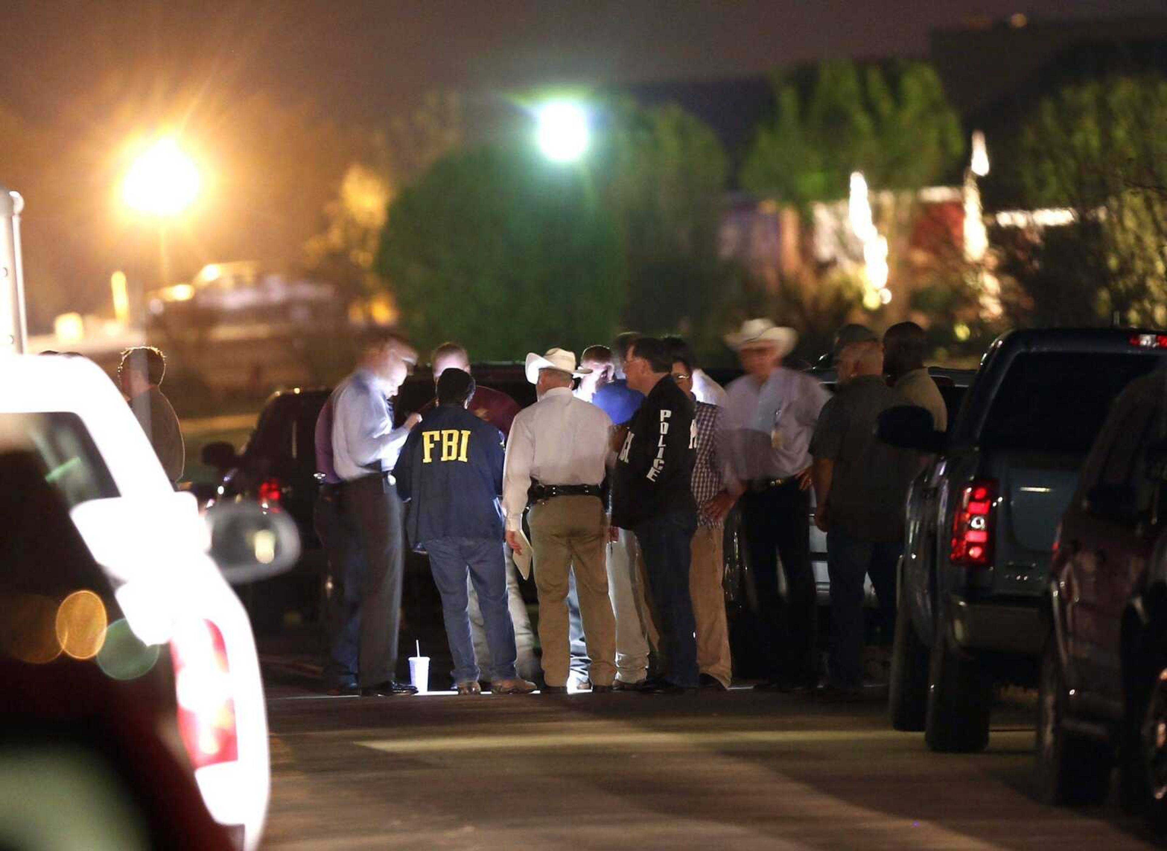 Authorities work in the middle of Blarney Stone Way where Kaufman County District Attorney Mike McLelland and wife Cynthia McLelland were found dead in their home Saturday in Forney, Texas. (Ian C. Bates ~ The Dallas Morning News)