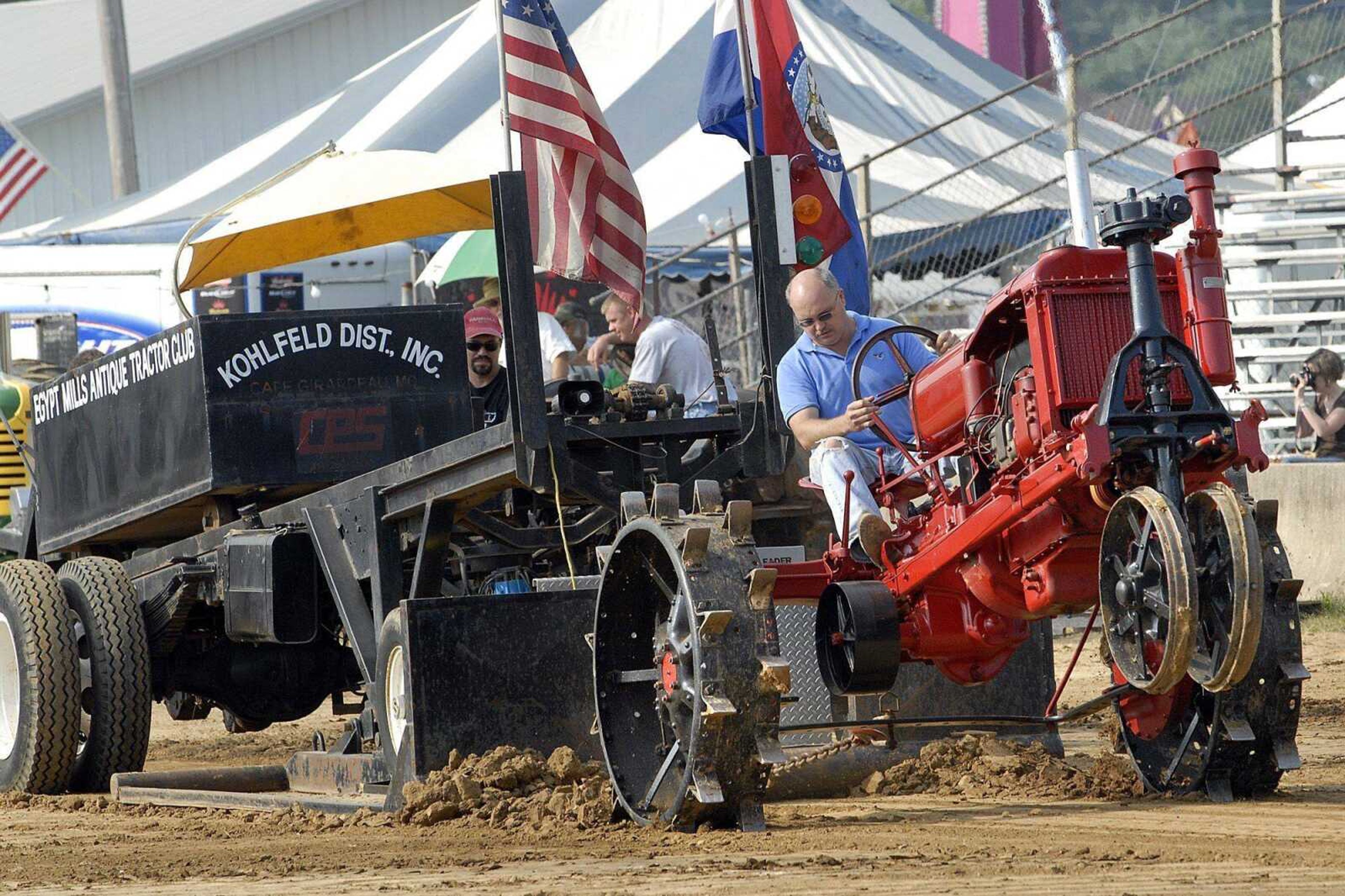 Wade Williams of Cape Girardeau drives his 1937 McCormick-Deering F-20 tractor in the 2-plow medium steel wheel division of the antique tractor pull at the SEMO District Fair. (Fred Lynch)