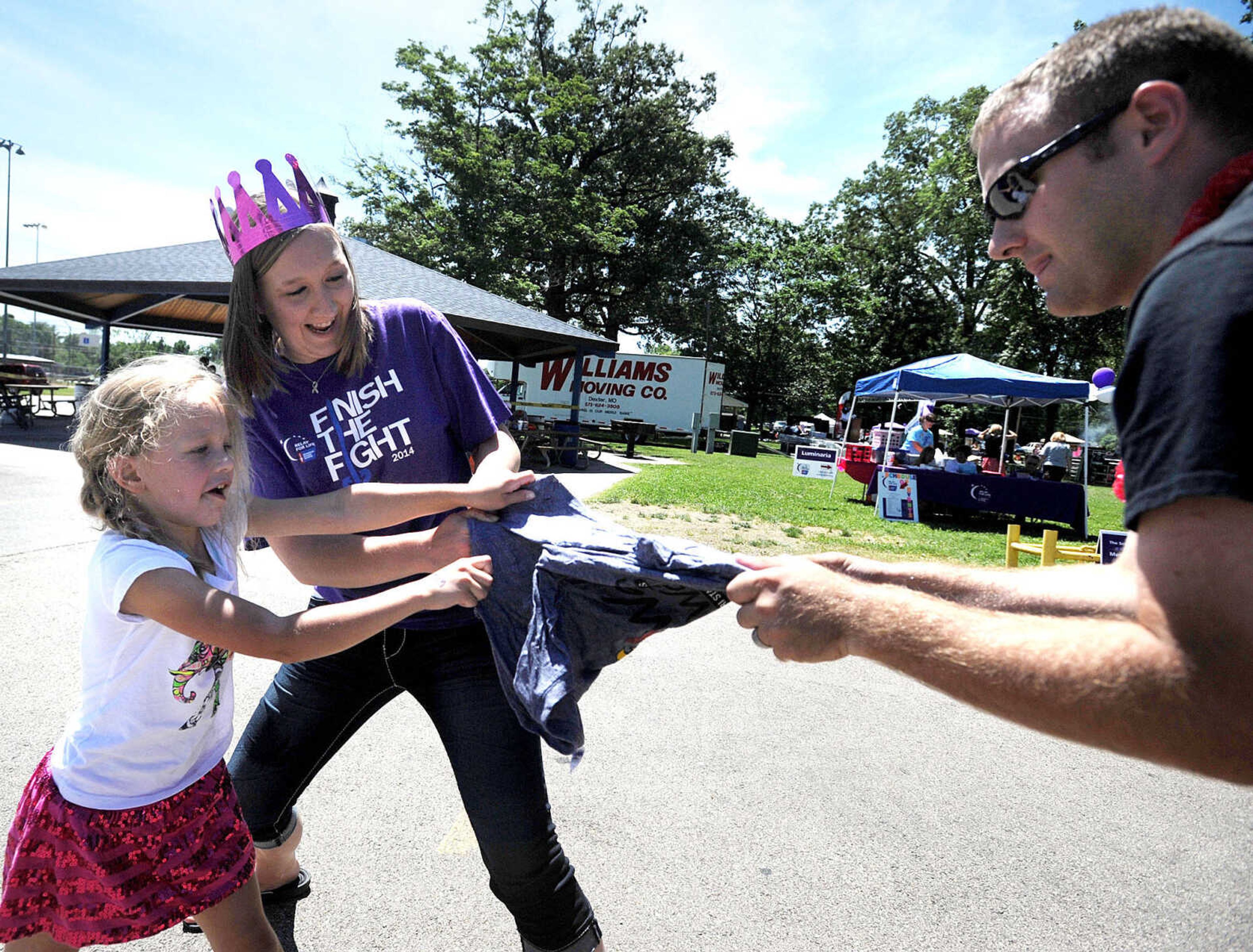 LAURA SIMON ~ lsimon@semissourian.com

Lily Botherton, left, and Renee and Matt Scroggins try to pull apart a frozen t-shirt, Saturday, June 14, 2014, during the Relay for Life of Cape Girardeau County fundraiser at Arena Park.