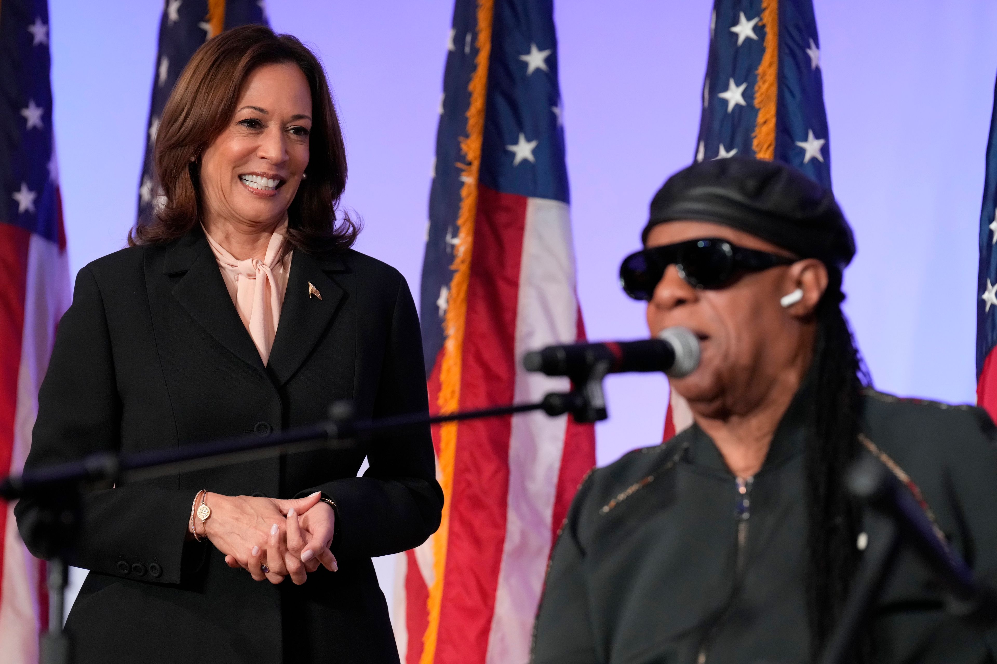 Democratic presidential nominee Vice President Kamala Harris looks on as Stevie Wonder sings "Happy Birthday" to Harris during a church service and early vote event at Divine Faith Ministries International, Sunday, Oct. 20, 2024, in Jonesboro, Ga. (AP Photo/Jacquelyn Martin)