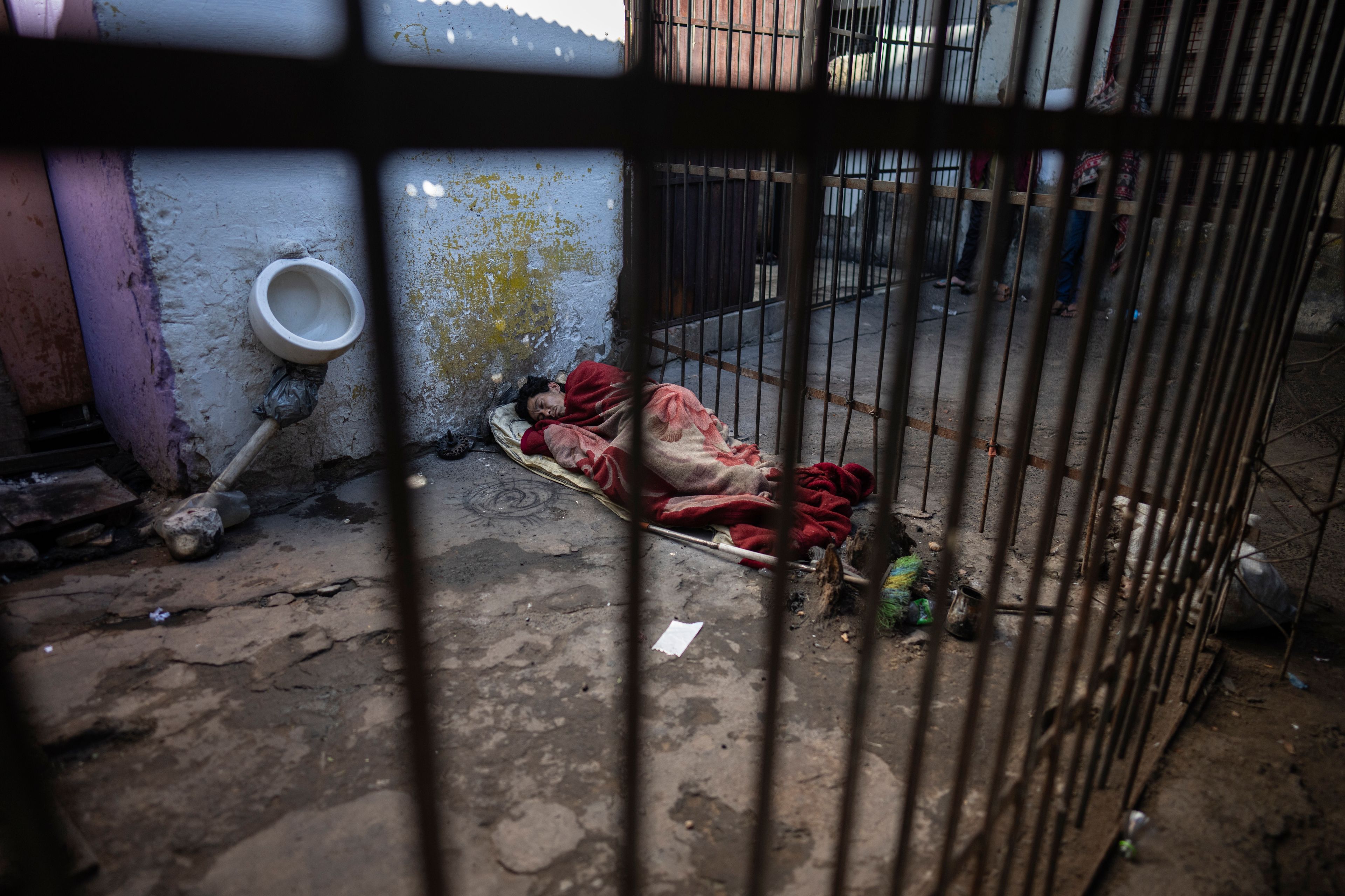 A prisoner rests in an external corridor of the Tacumbu prison in Asuncion, Paraguay, Sunday, July 8, 2024. (AP Photo/Rodrigo Abd)