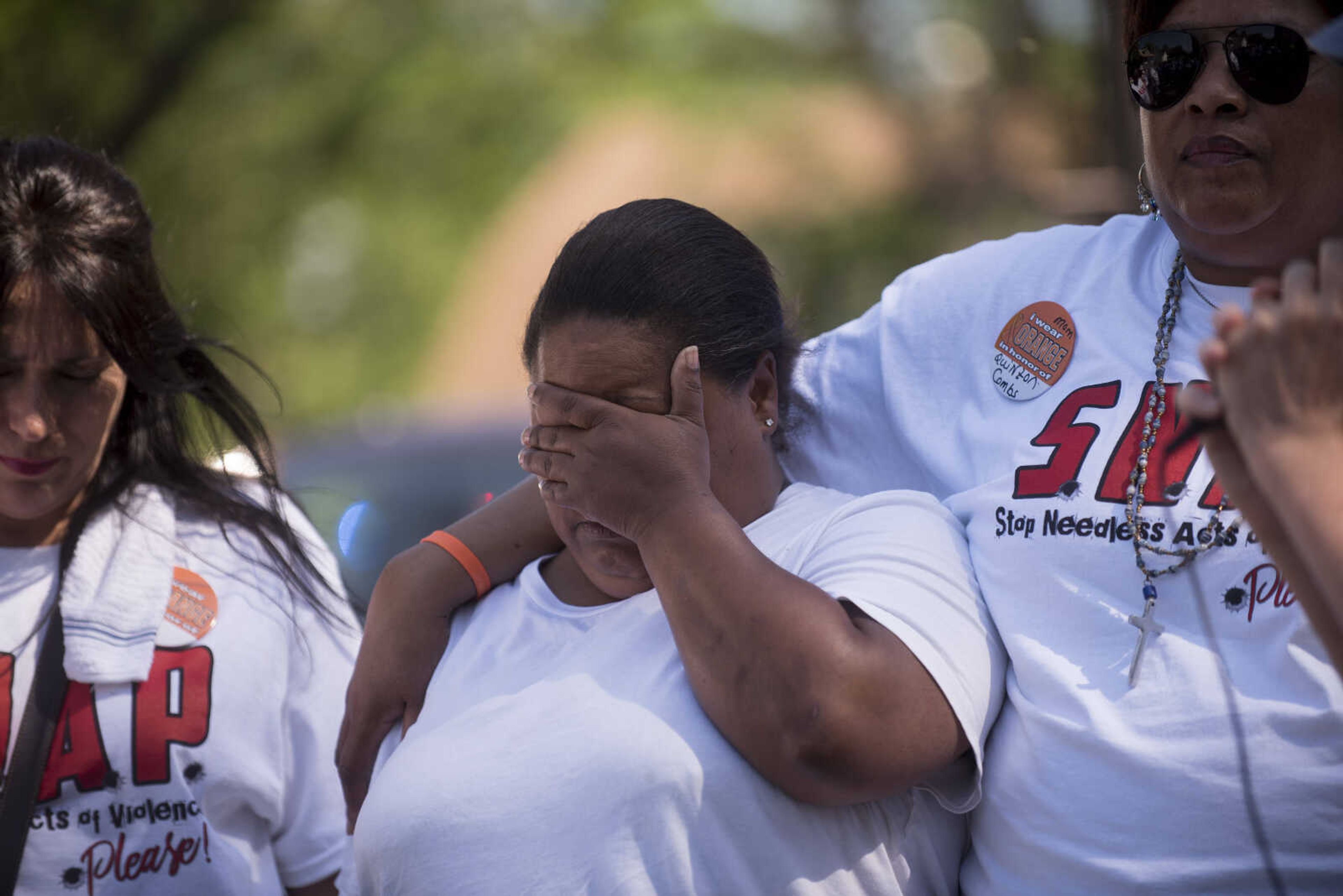 Family members say a prayer at the house where 6-year-old Markell Beasley was shot to death in 2013 during a Stop Needless Acts of Violence Please (SNAP) prayer march Saturday, June 10, 2017 in Cape Girardeau.