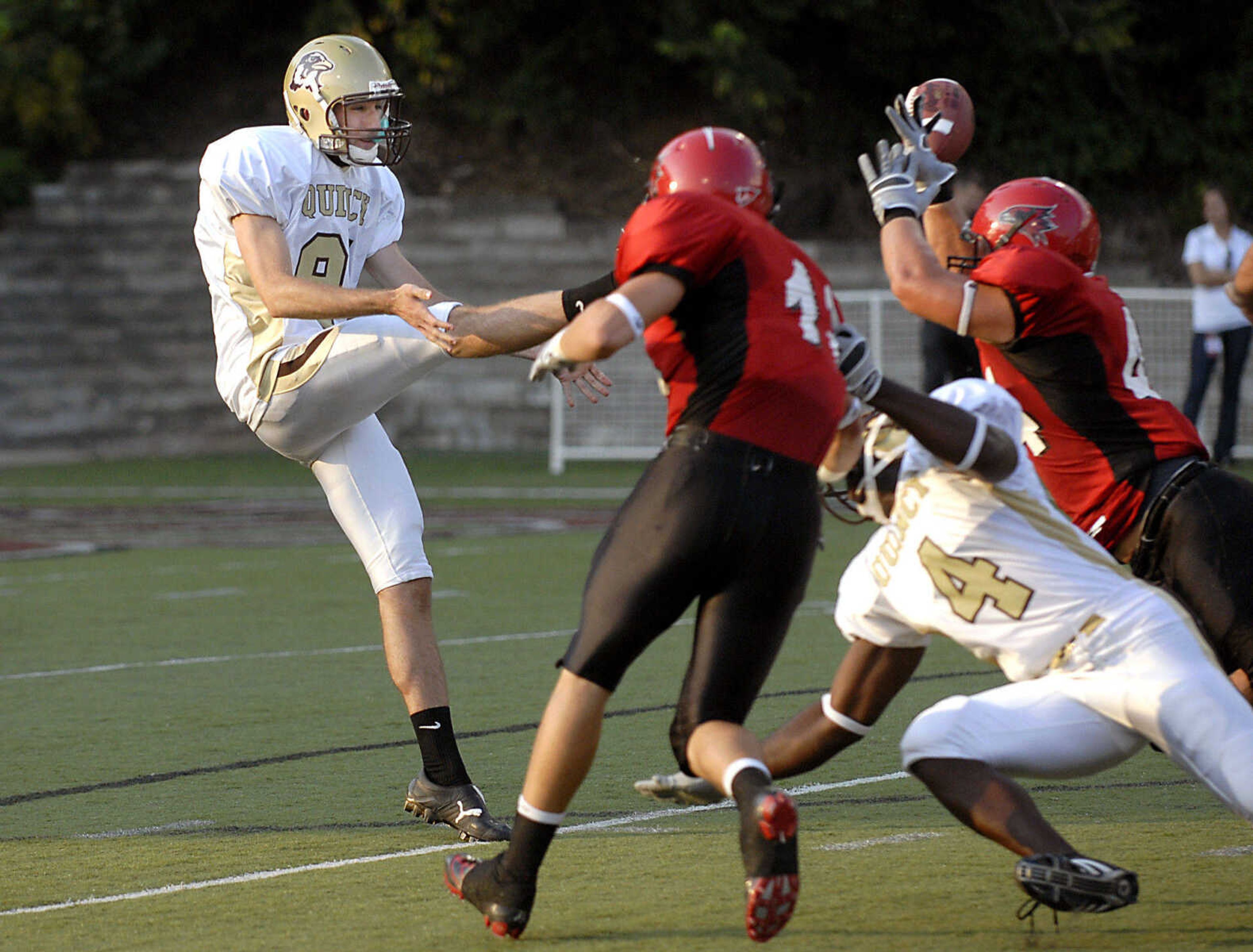 KIT DOYLE ~ kdoyle@semissourian.com
Redhawks defenders block the punt of Quincy kicker Kyle Homeyer Thursday, September 3, 2009, in the season opener at Houck Stadium.  Southeast recovered the blocked punt in the end zone for a touchdown.