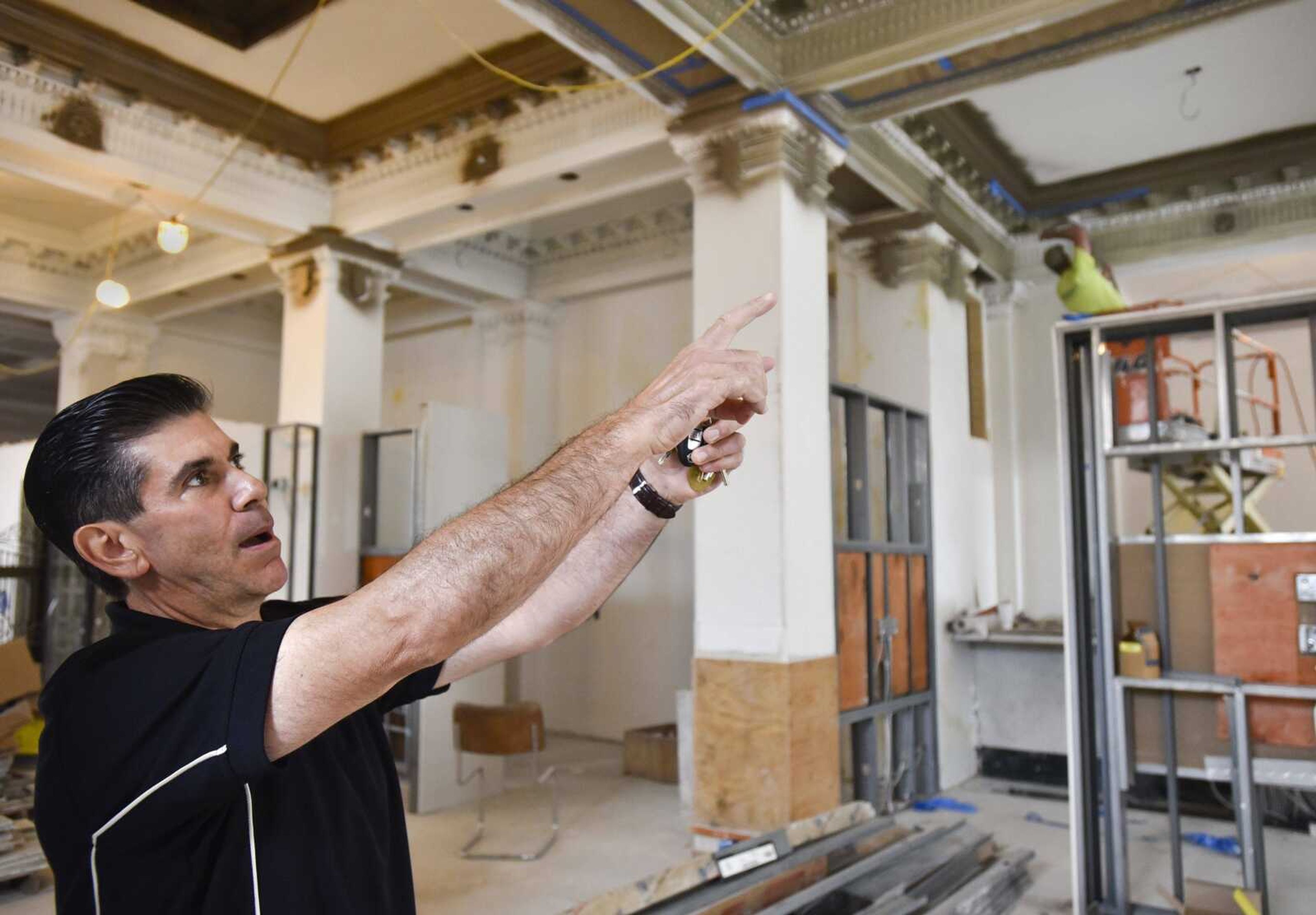 Andre Borrelli points out ornamental designs he restored in the lobby of the former H-H Building as he gives a tour Wednesday in Cape Girardeau.