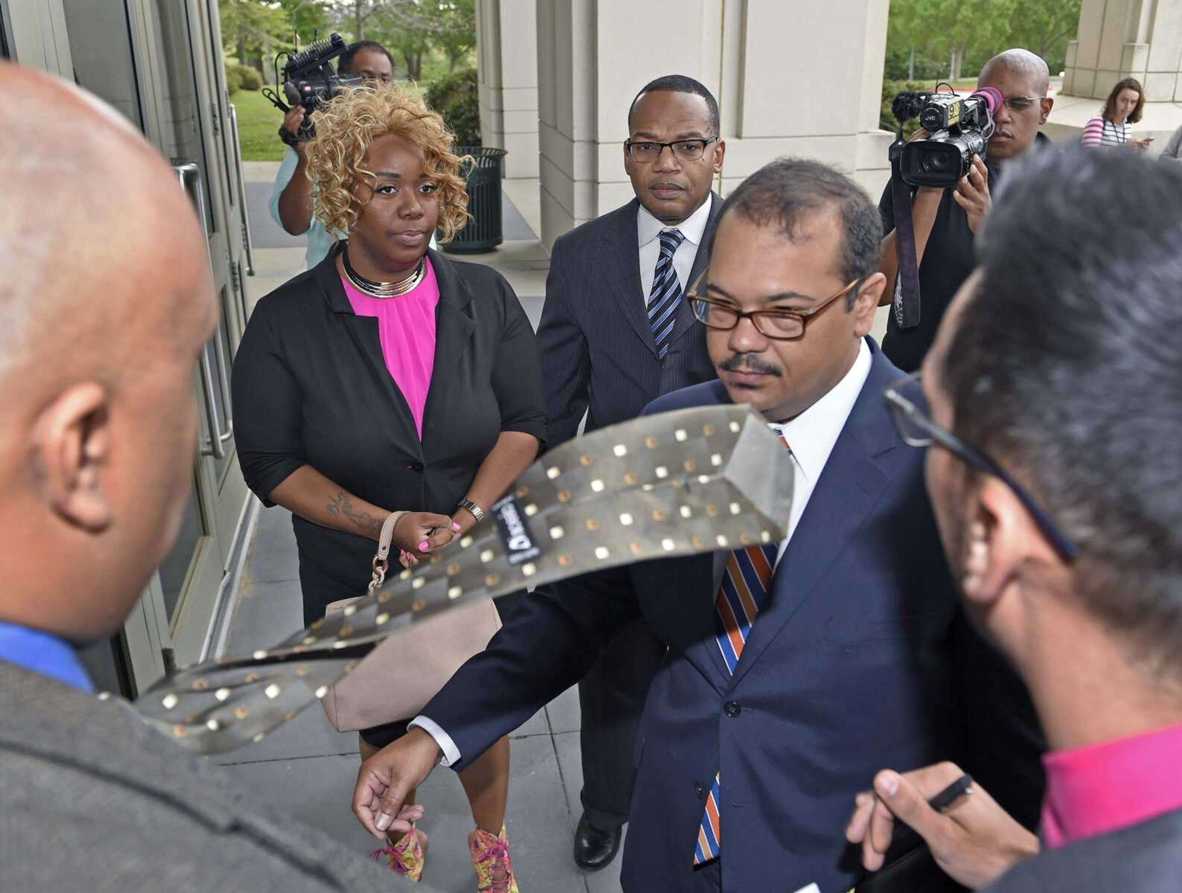 From left, Andricka Williams, attorney Mike Adams and attorney Brandon DeCuir arrive Tuesday for a meeting with Attorney General Jeff Landry in Baton Rouge, Louisiana, to report his office's findings.