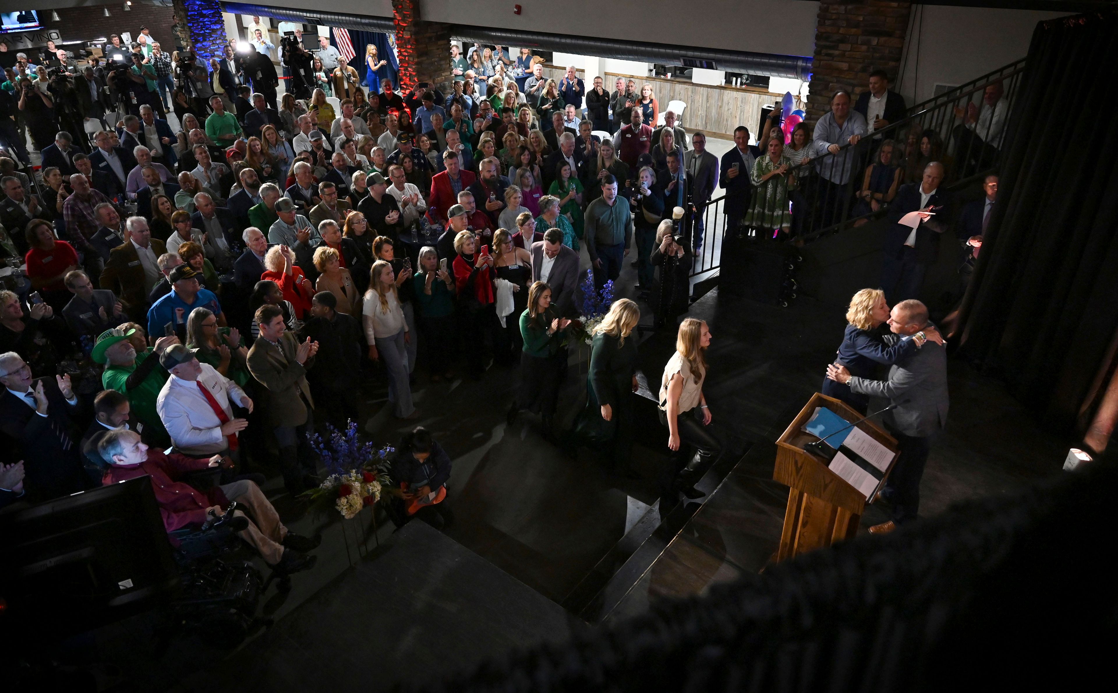 Republican Governor-elect Mike Kehoe, right, hugs his family as they greet him onstage after his speech on election night Tuesday, Nov. 5, 2024, at the Capital Bluffs Event Center in Jefferson City, Mo. (Bailey Stover/Missourian via AP)