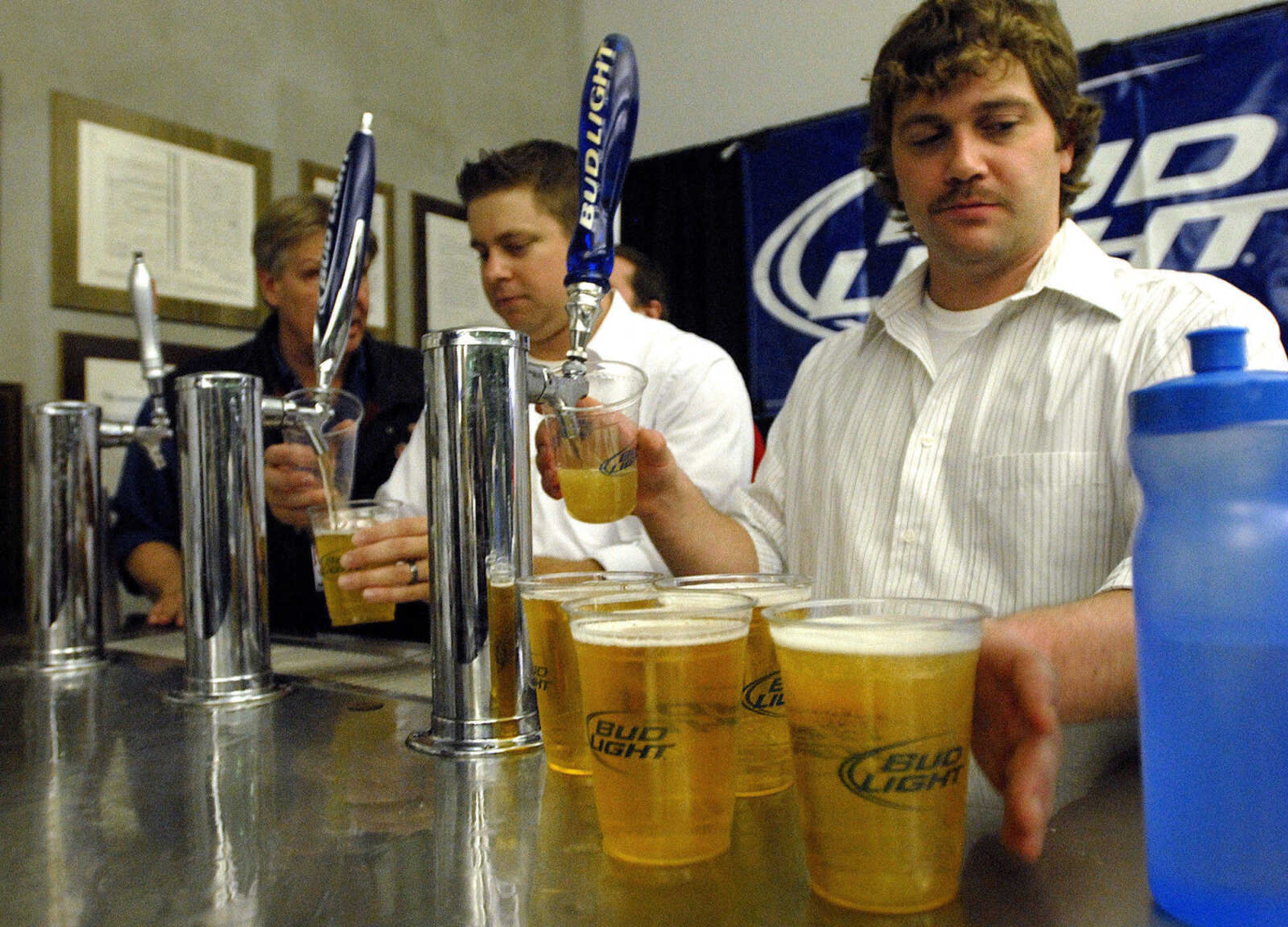 LAURA SIMON ~ lsimon@semissourian.com
James Cain, right, and Wayne Essner keep up with the customers in line for beer Friday night, January 20, 2012 during the "Blood, Sweat and Beers Tour" at the Show Me Center in Cape Girardeau.