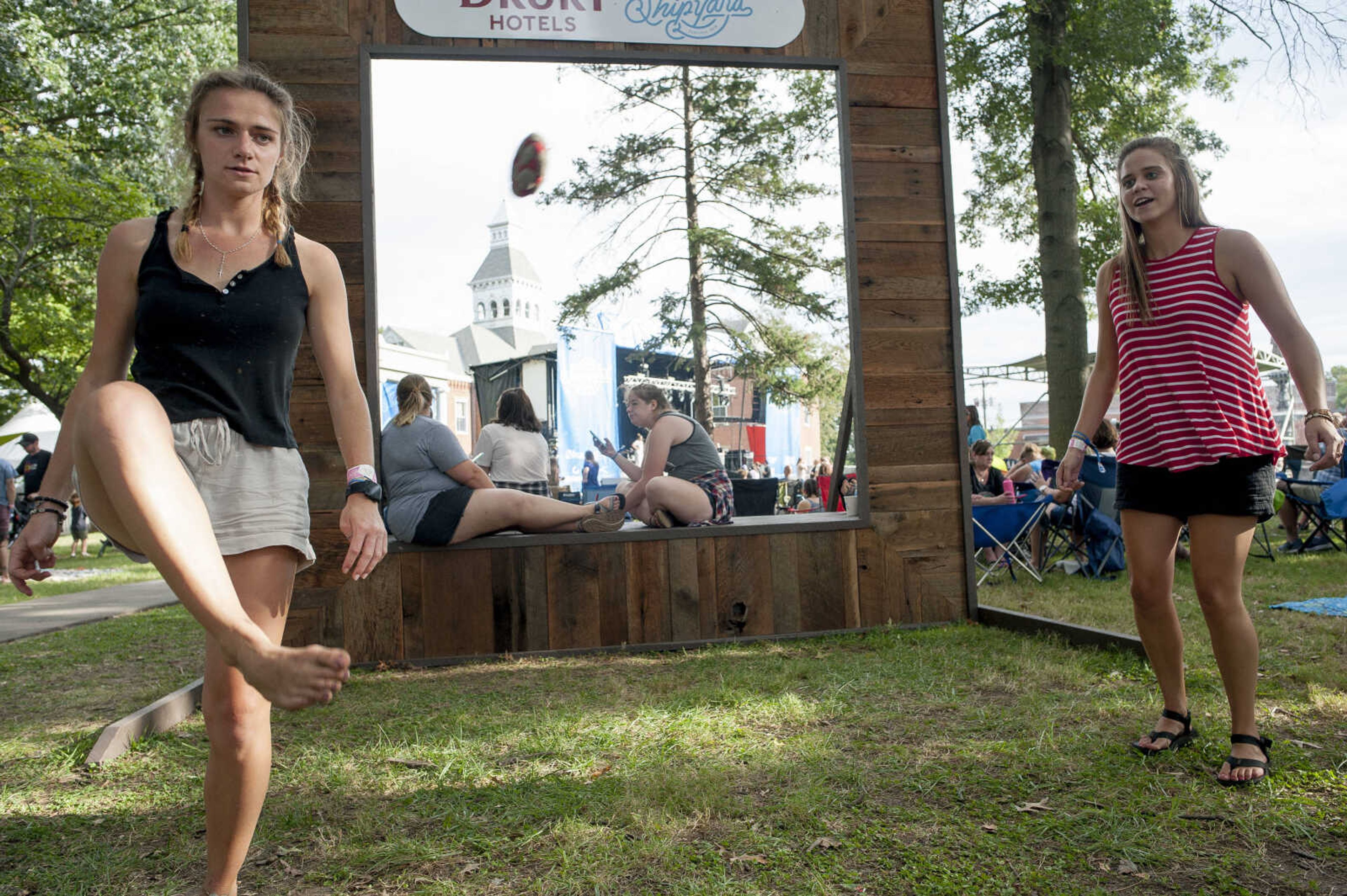 Amy Krebs, left, passes a hacky-sack to Shelly Wolf (not pictured) while playing with Erin Pendergast, right, during the second-annual Shipyard music festival Saturday, Sept. 28, 2019, at Ivers Square in Cape Girardeau.