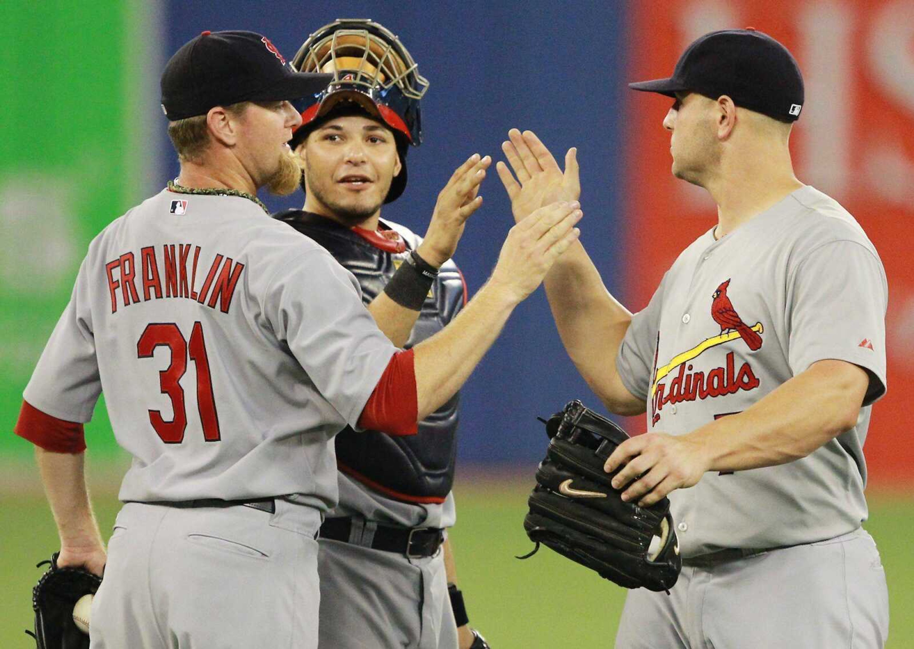 Cardinals closer Ryan Franklin, catcher Yadier Molina and outfielder Matt Holliday celebrate their win over the Blue Jays on Wednesday.