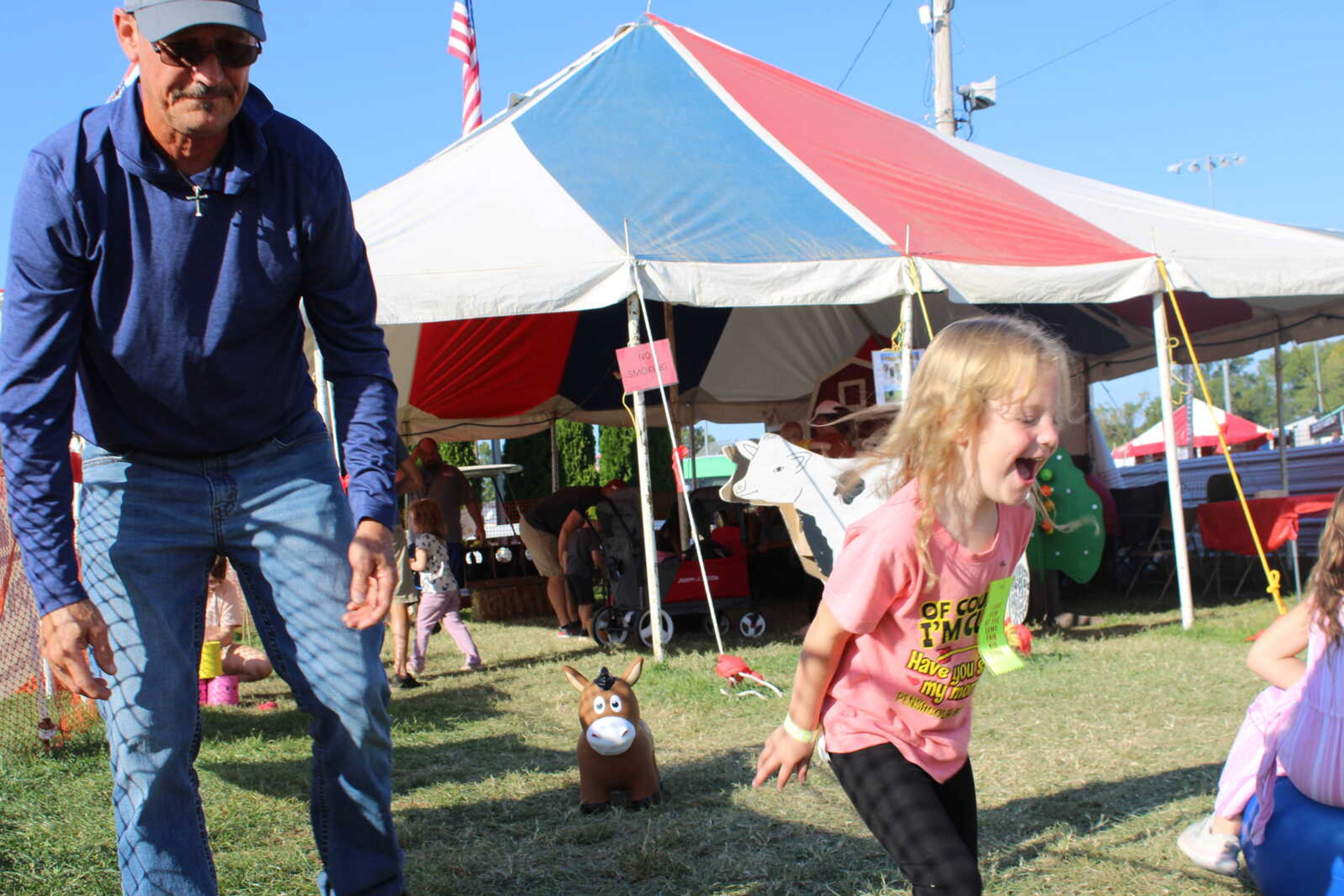 Ava Weaver celebrates throwing her rings on the pole in the ground along side her grandpa Danny Weaver.