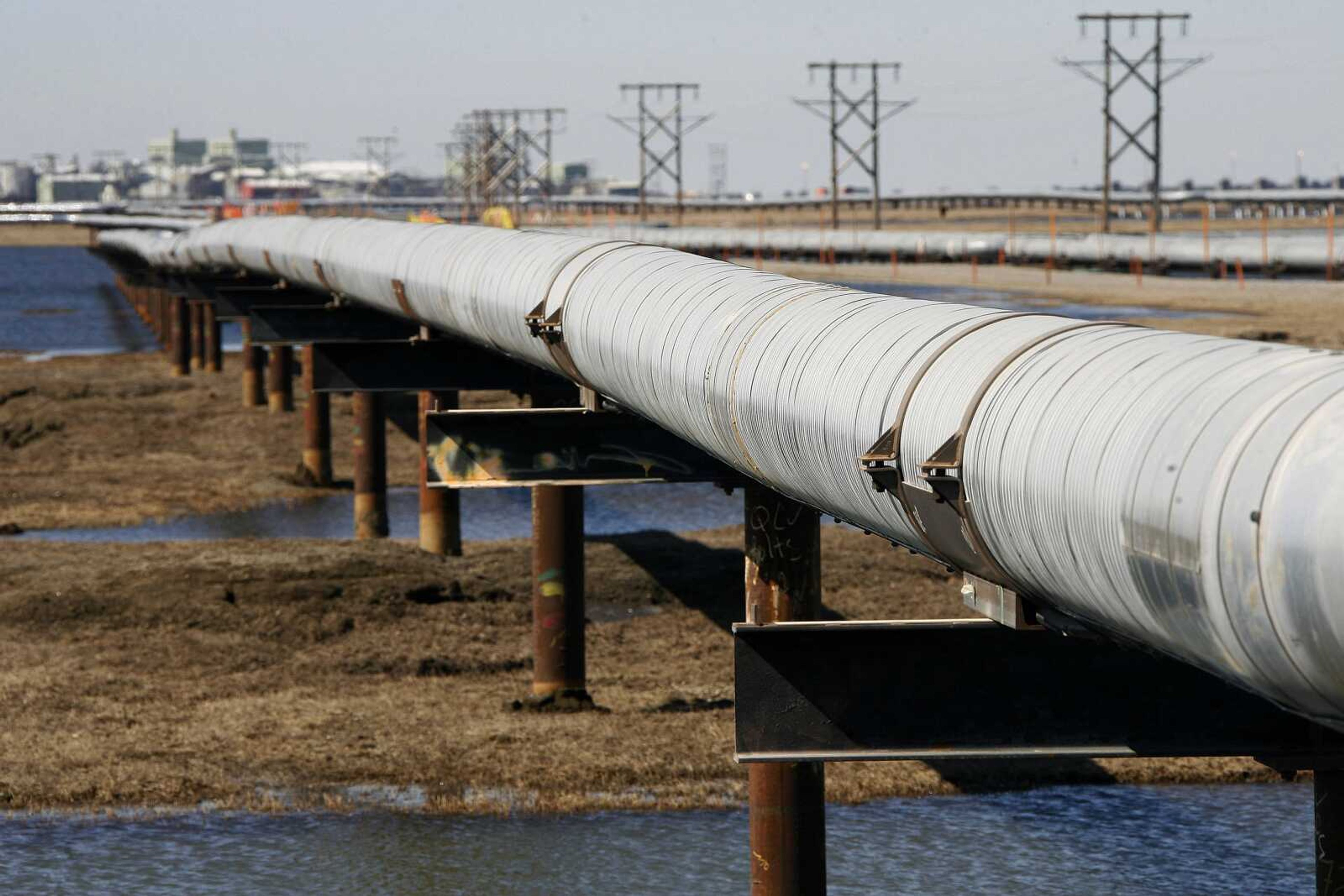 An oil pipeline runs across the tundra to flow station at the Prudhoe Bay oil field on Alaska's North Slope. The Obama administration is blocking new oil and gas drilling in the Arctic Ocean.