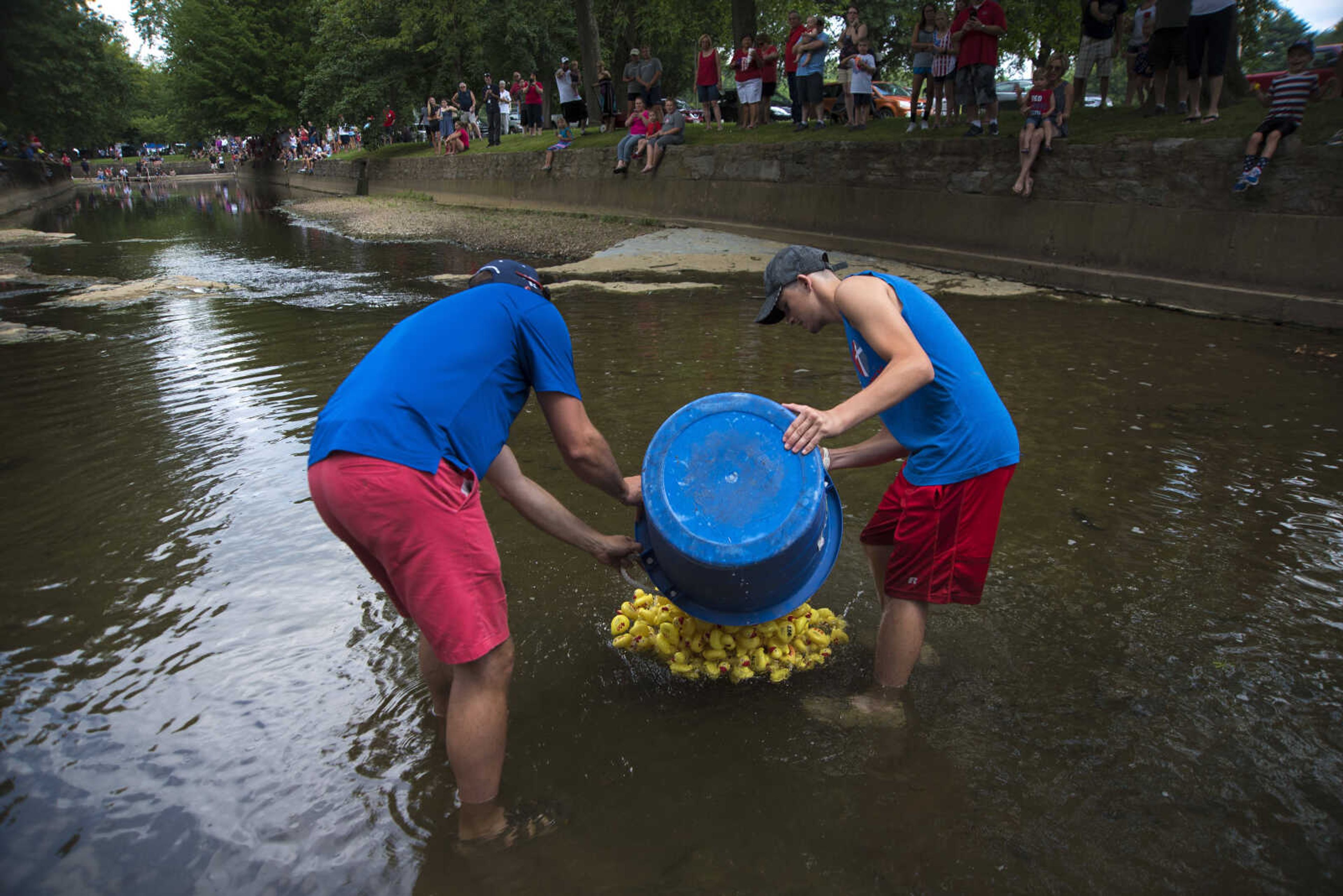 Rubber ducks are poured into the creek during the duck race for the Jackson Parks and Recreation's July 4th celebration Tuesday, July 4, 2017 in Jackson City Park.