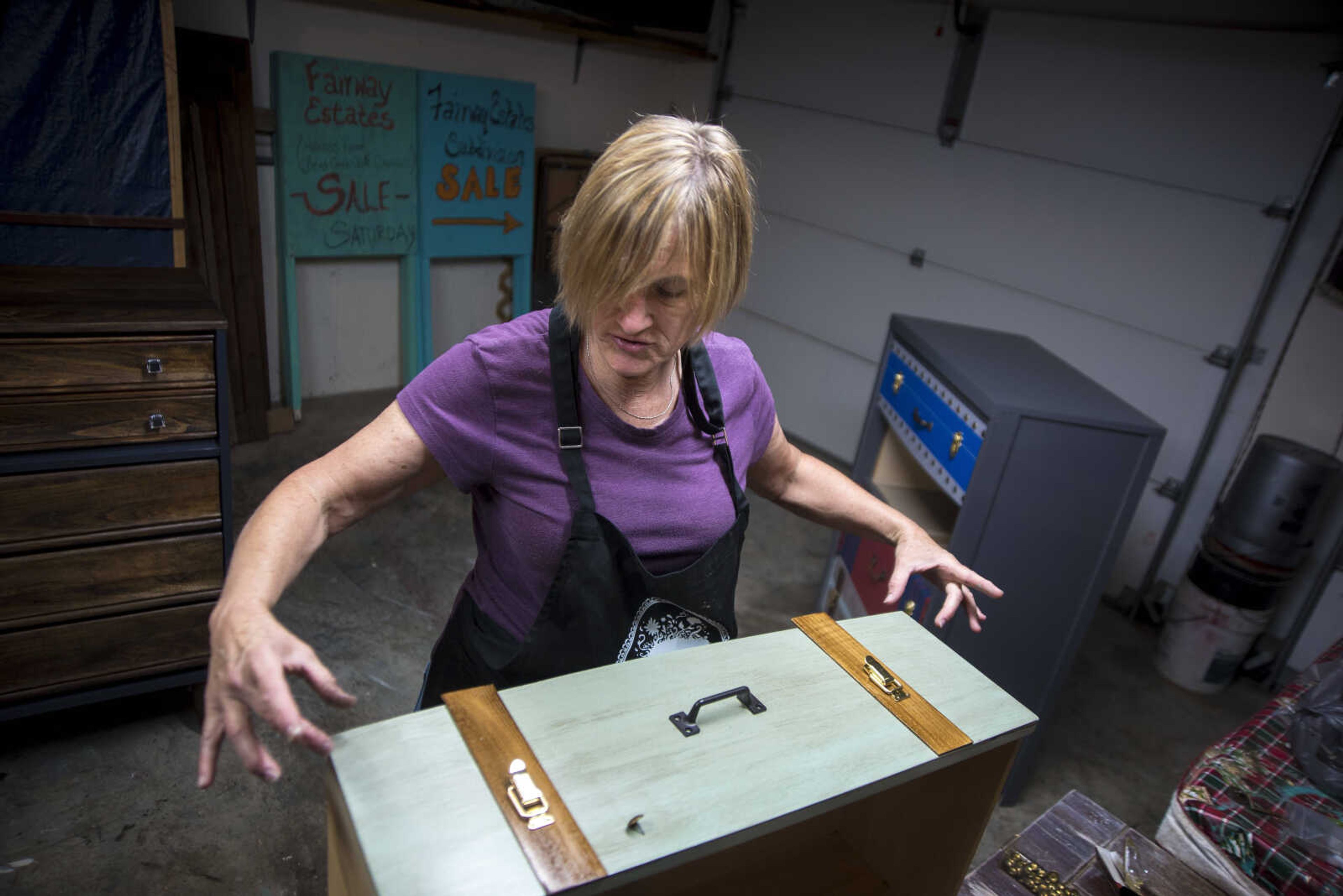 "It's kind of like a puzzle." Debbie Birk said talking about when she creates new furniture out old and some times thrown out furniture. Debbie lines up pieces of her drawer to match the look of a suitcase she is building in her garage Wednesday, July 26, 2017 in Jackson. Birk has a booth at Judith's Antiques in downtown Cape Girardeau where she sells her remodeled furniture.