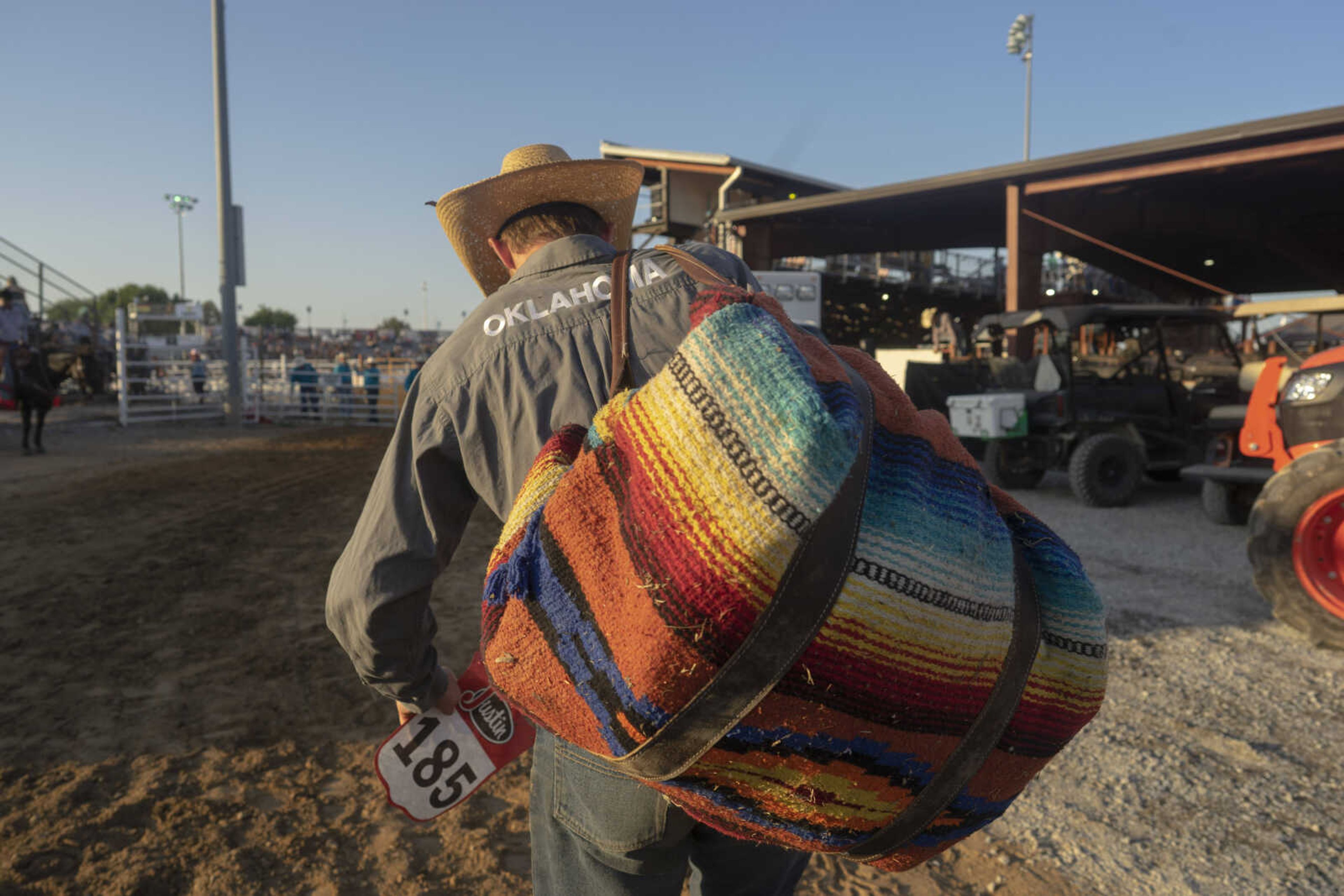 Bullrider Jesse Hopper of Mangum, Oklahoma, makes his way to the arena before the first night of the Sikeston Jaycee Bootheel Rodeo on Wednesday, Aug. 11, 2021, in Sikeston, Missouri.