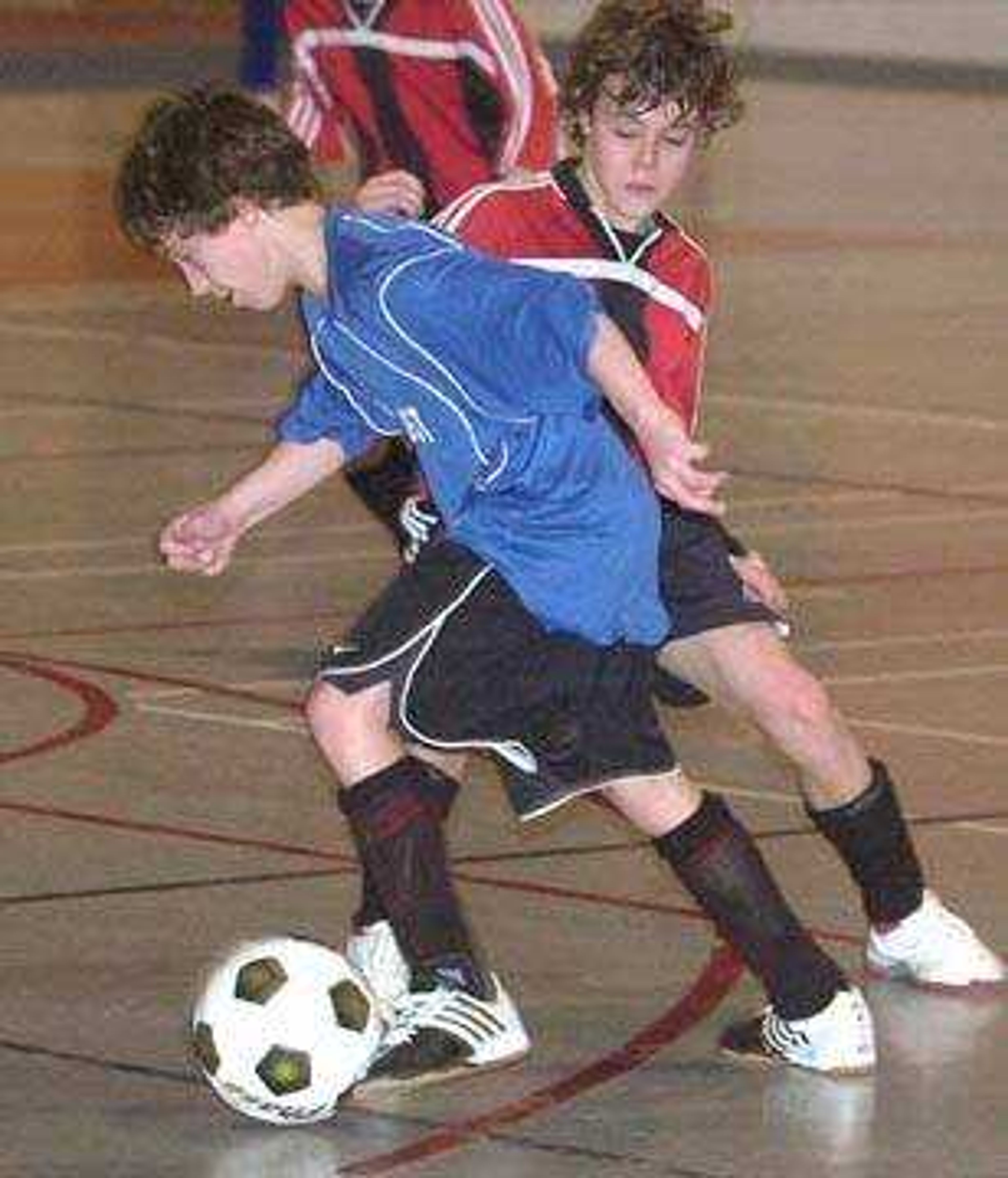 Brock Dirnberger, front, with SMSC Warriors White moved the ball past Mitchell McCulley with Jackson Indians in boys 13-under. The Warriors won 5-1.