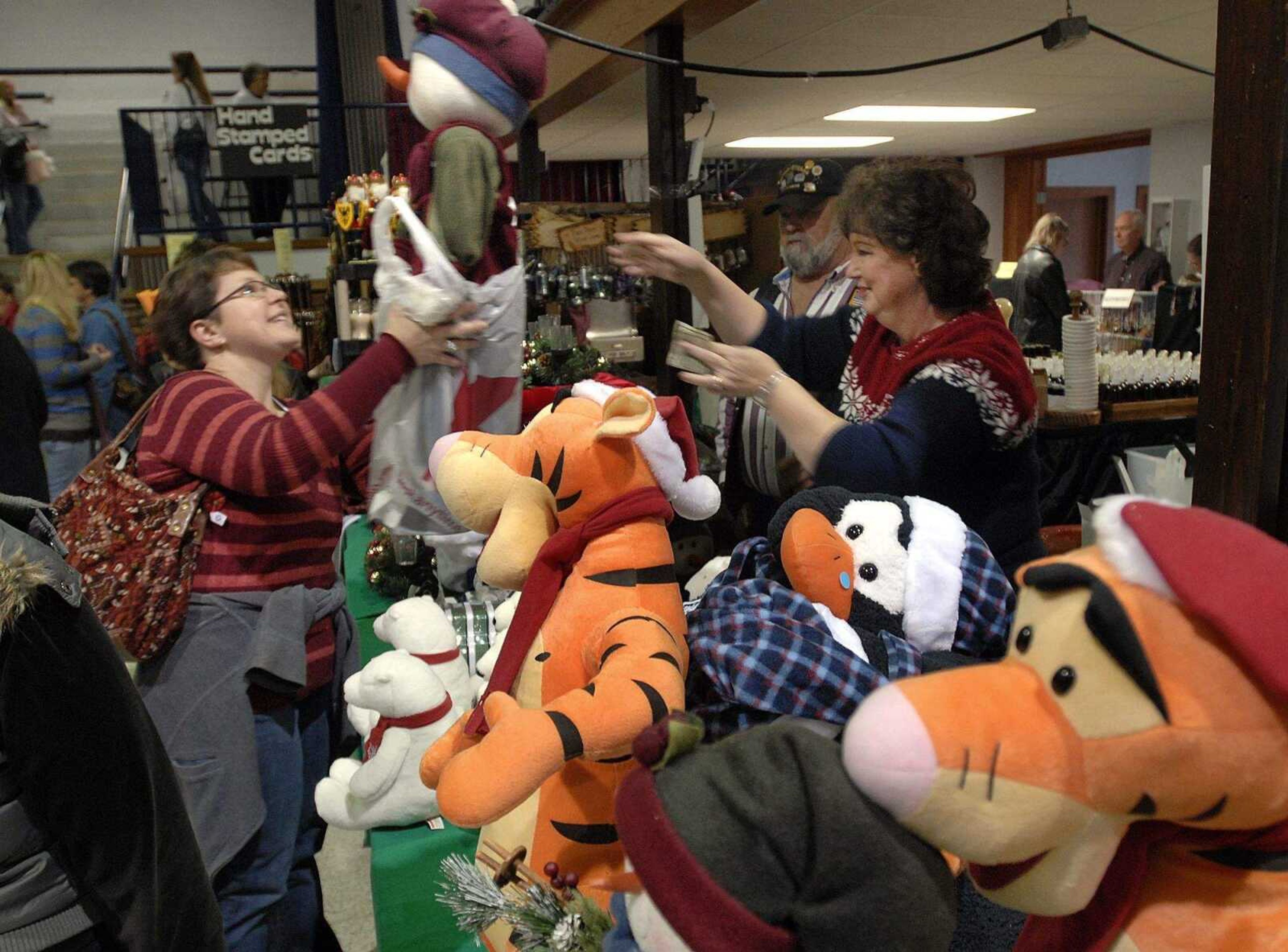 FRED LYNCH ~ flynch@semissourian.com
Angie Whitfield, left, of Scott City buys a crafted snow girl from Wanda Scott of Henderson, Tenn. at the River Valley Craft Club Christmas Expo Saturday at the Arena Building.