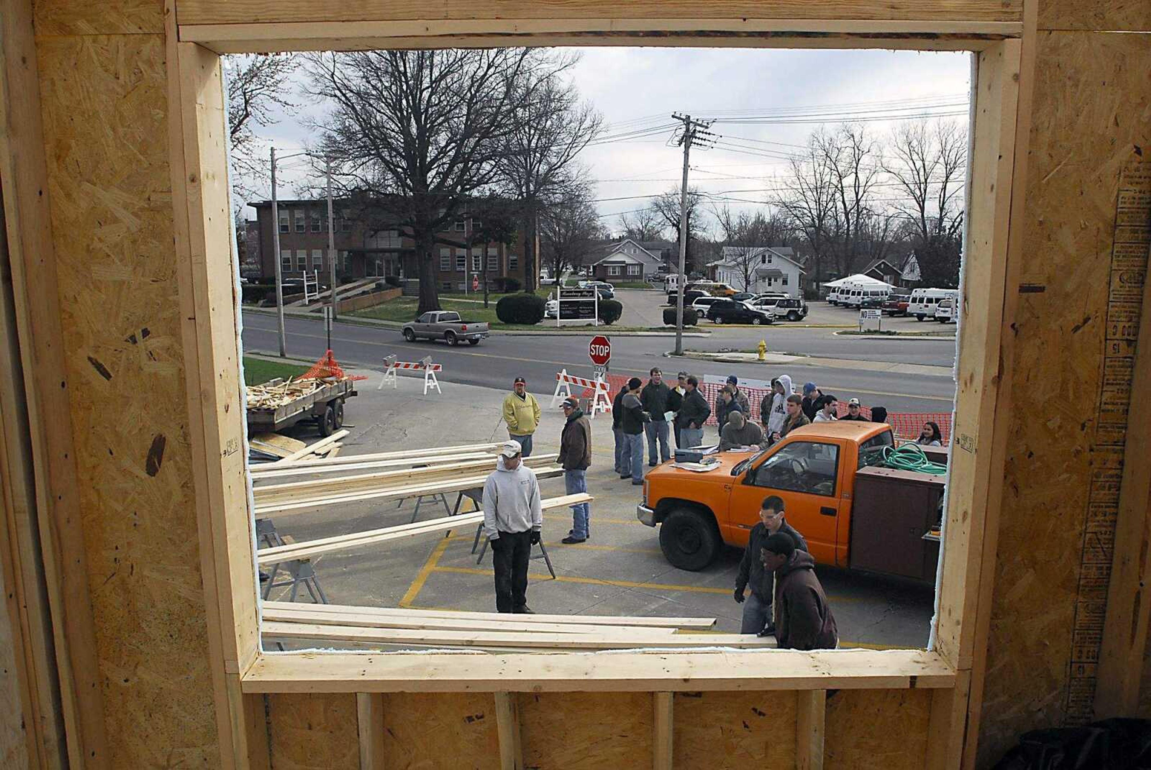 KIT DOYLE ~ kdoyle@semissourian.com
Volunteers gather outside a Habitat for Humanity house being built in the Alumni Center parking lot Wednesday, March 11, 2009, in Cape Girardeau.