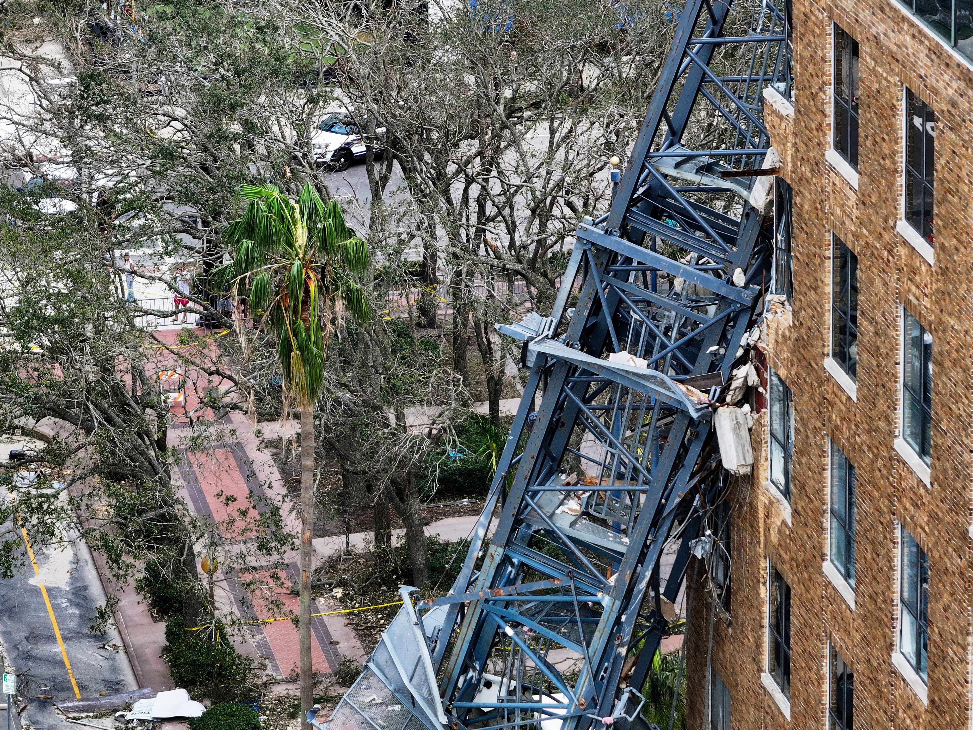 An aerial drone view of the scene where a downtown high-rise was smashed by a fallen crane from Hurricane Milton at 490 1st Avenue South, Friday, Oct. 11, 2024 in St. Petersburg, Fla. The building damaged by Hurricane Milton is home to the Tampa Bay Times, a law firm, a defense contractor and more. (Dirk Shadd/Tampa Bay Times via AP)