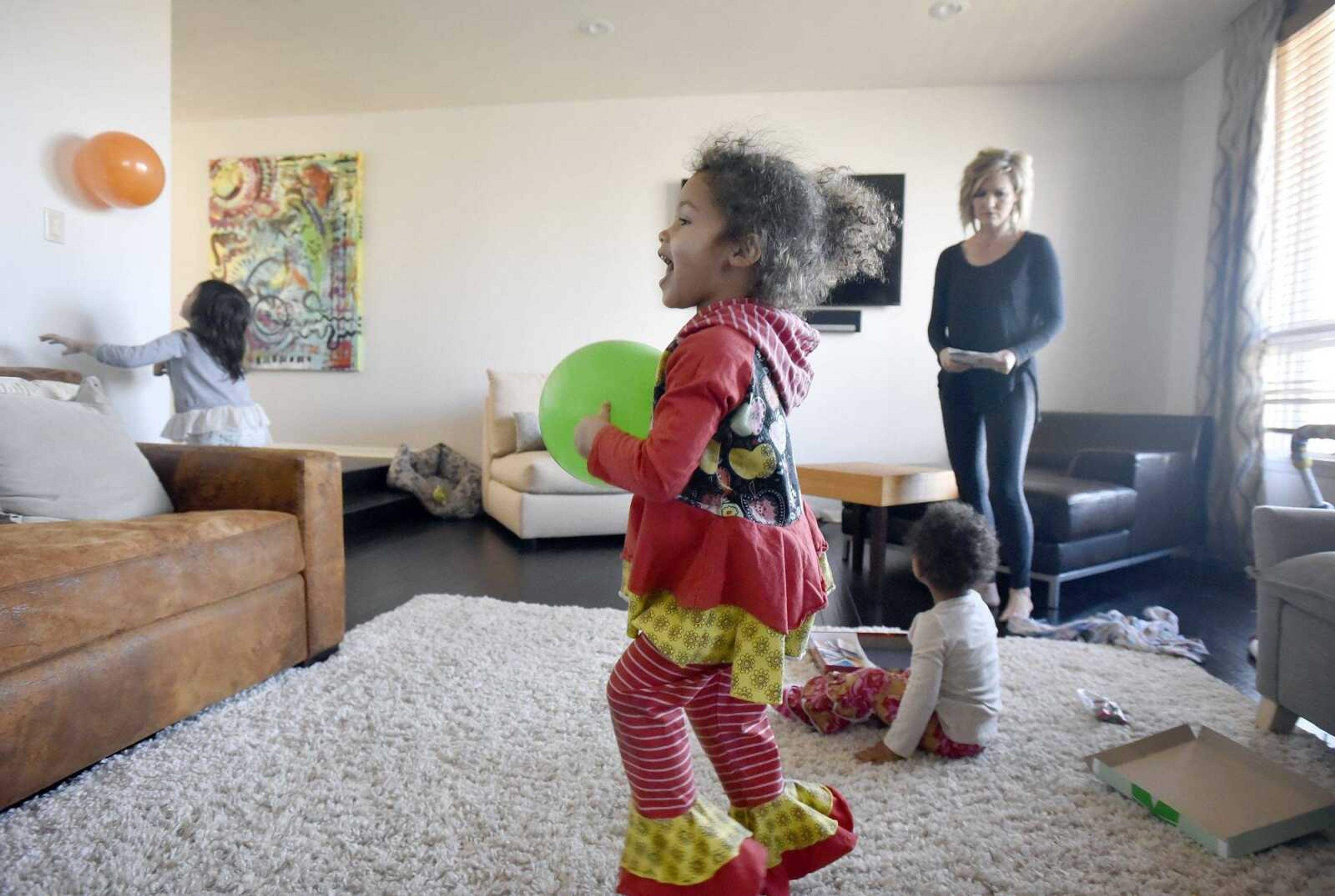 Chantelle Becking watches over her daughters, Ari, left, Dolly, center, and Lennyx as they play in the family room on Saturday, Jan. 28, 2017, at the Becking's Cape Girardeau home.