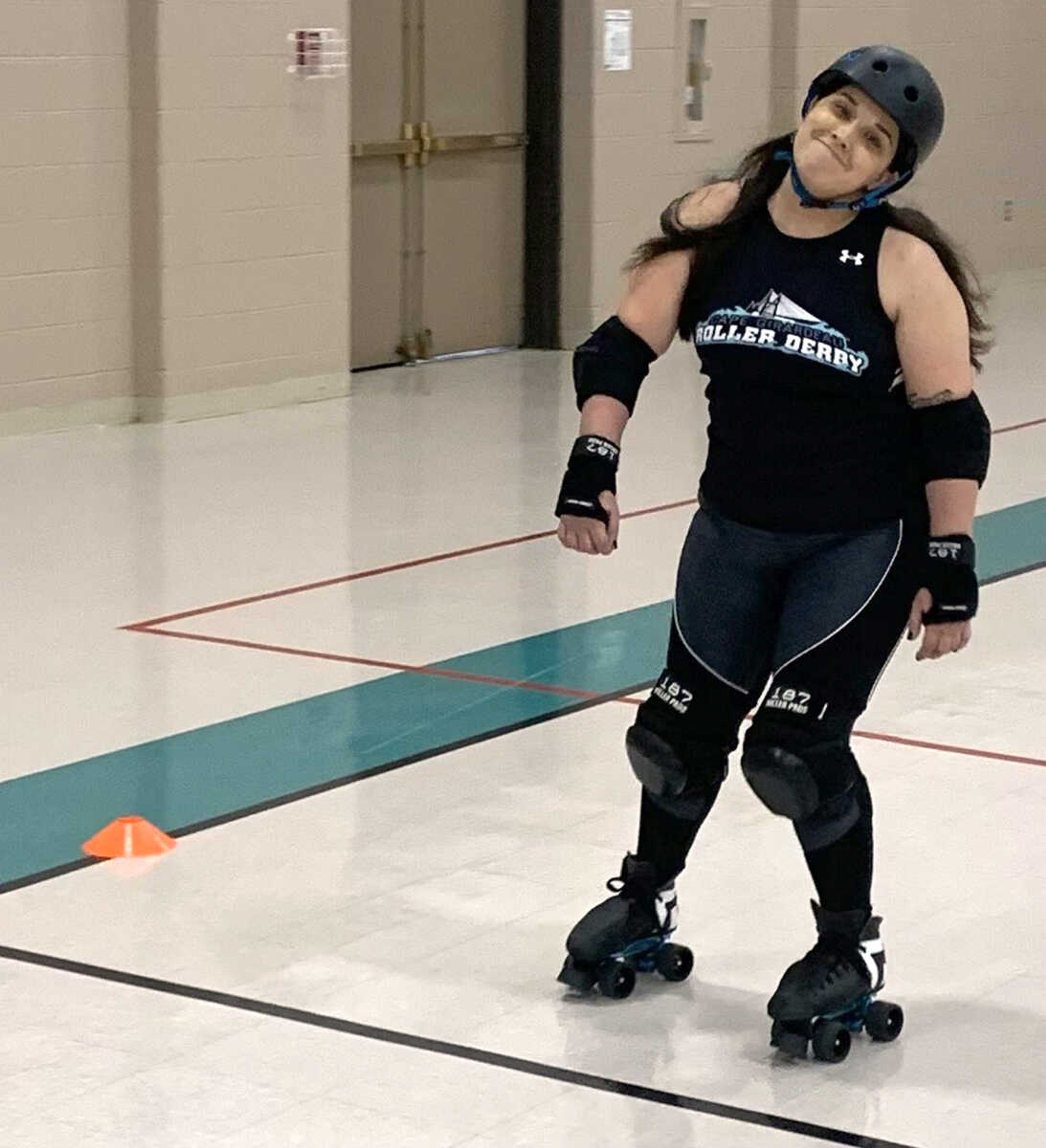 Bri DeWitt warms up during a Cape Girardeau Roller Derby practice recently at the Osage Centre gym in Cape Girardeau.