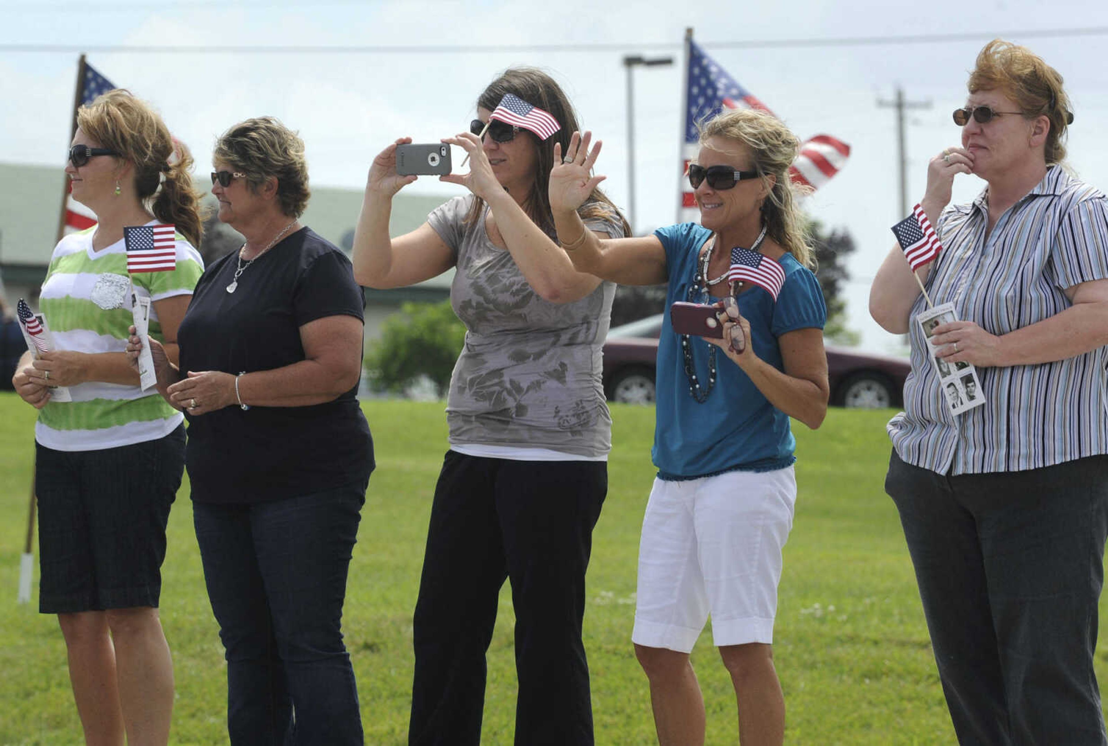 People welcome the motorcyclists riding with the The Wall That Heals on Tuesday, June 17, 2014 in Perryville, Mo.