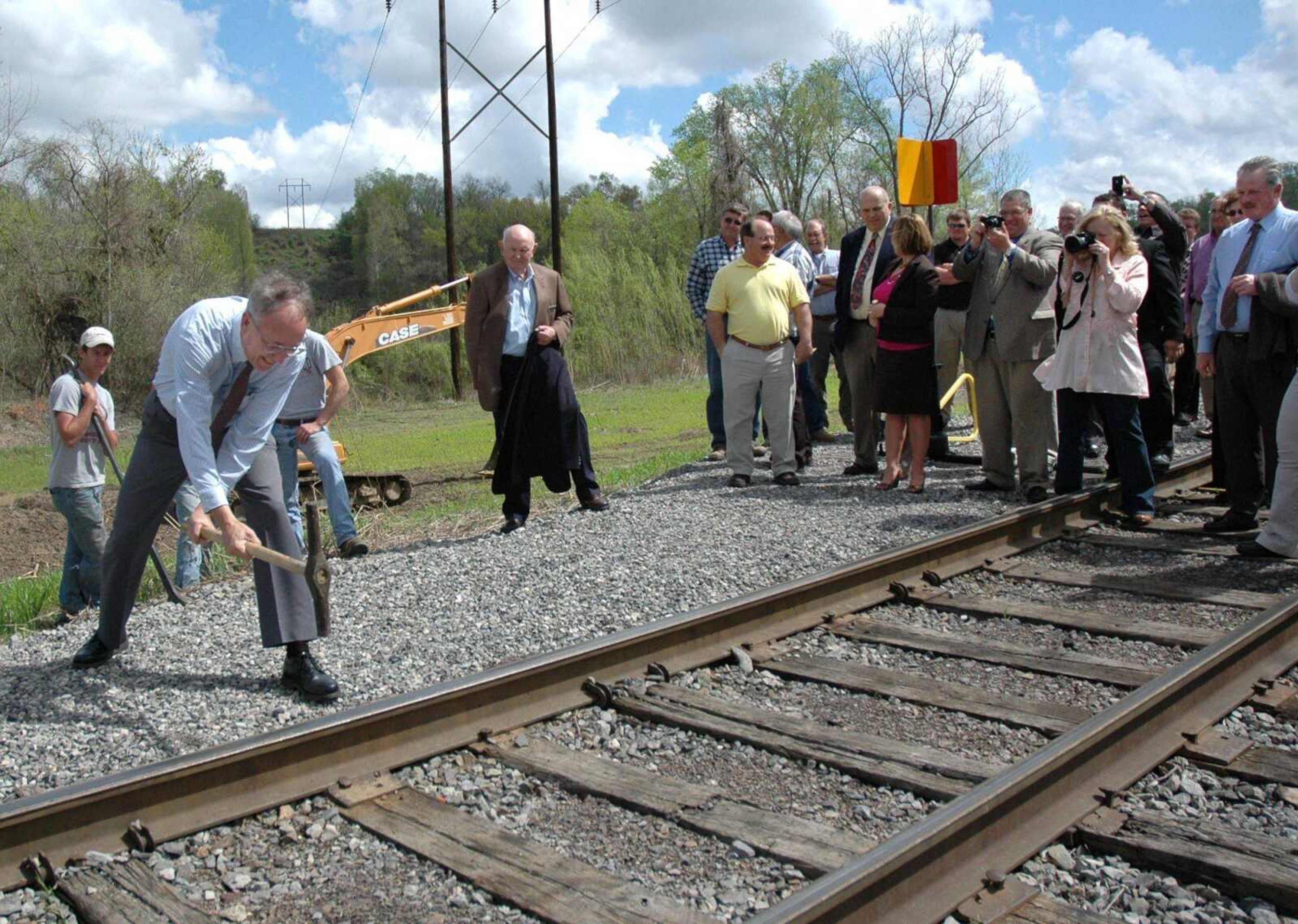 MELISSA MILLER ~ mmiller@semissourian.com<br>Dan Overbey, executive director of SEMO Port, hammers in a ceremonial<br>golden spike Friday, March 23, 2012 to signify the completion of a Second Main Line Track at the port. The half-mile section of railroad will help the port increase its rail capacity. It will also help the port avoid railroad closures due to high water, since it is at a higher elevation than the existing track.