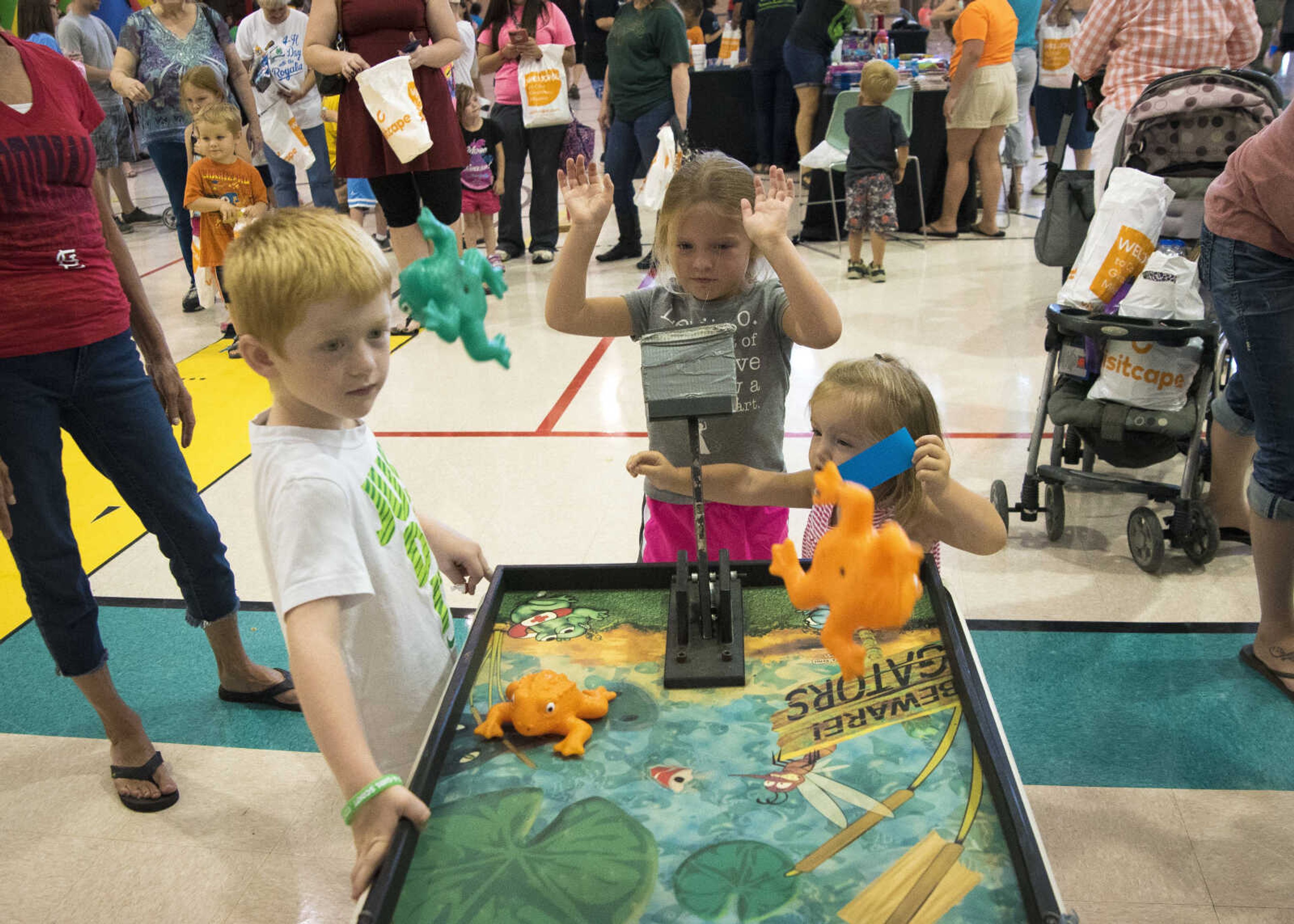 Brynlie Brazer, 5, center, launches a frog with Tayton Cathcart, 5, left, and Bella Brazer, 18 months, right, during the Parks and Rec Day Friday, July 7, 2017 at the Osage Centre in Cape Girardeau.