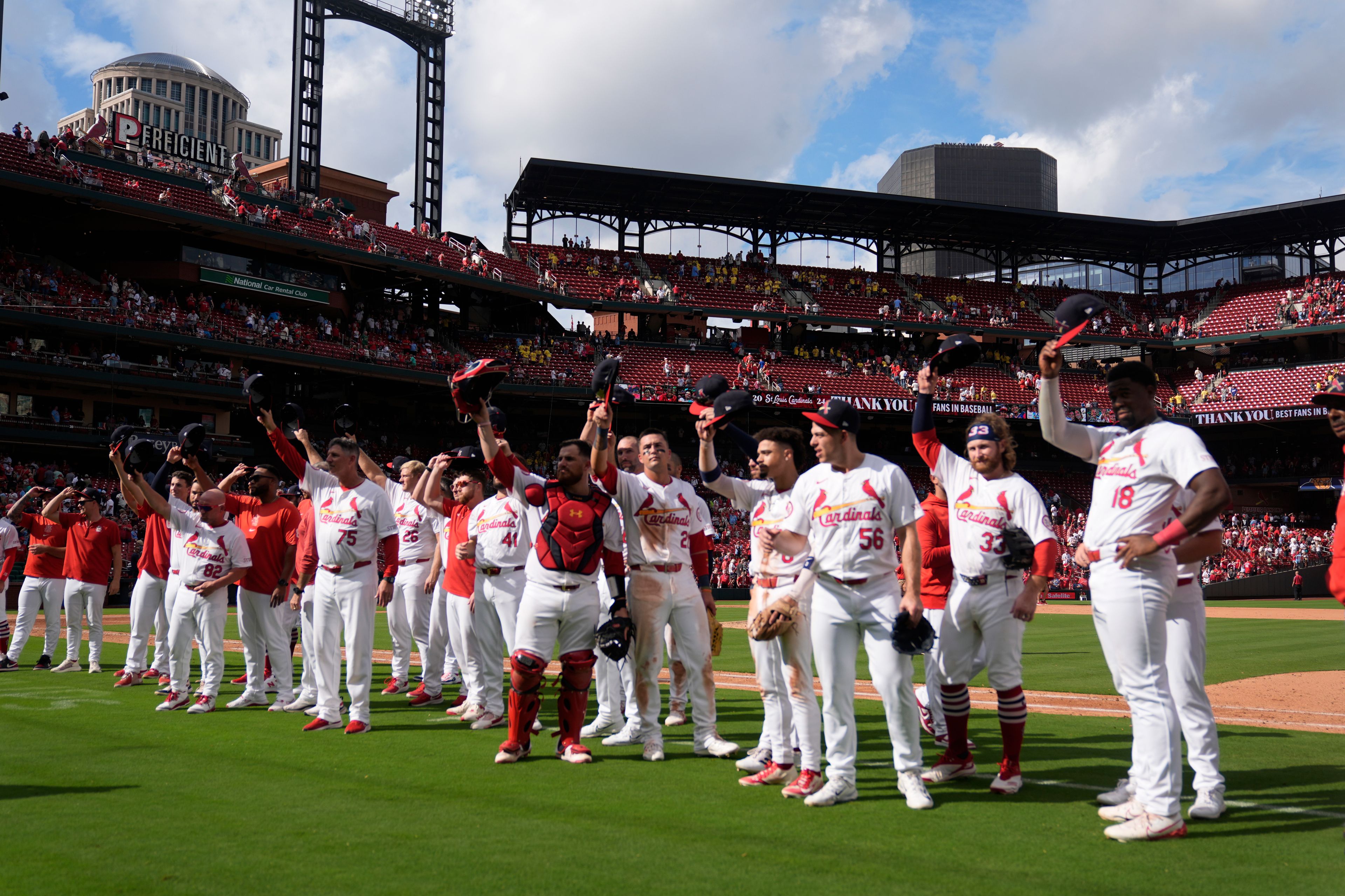 Members of the St. Louis Cardinals salute fans following a baseball game against the Cleveland Guardians, the Cardinals final home game of the season, Sunday, Sept. 22, 2024, in St. Louis. (AP Photo/Jeff Roberson)