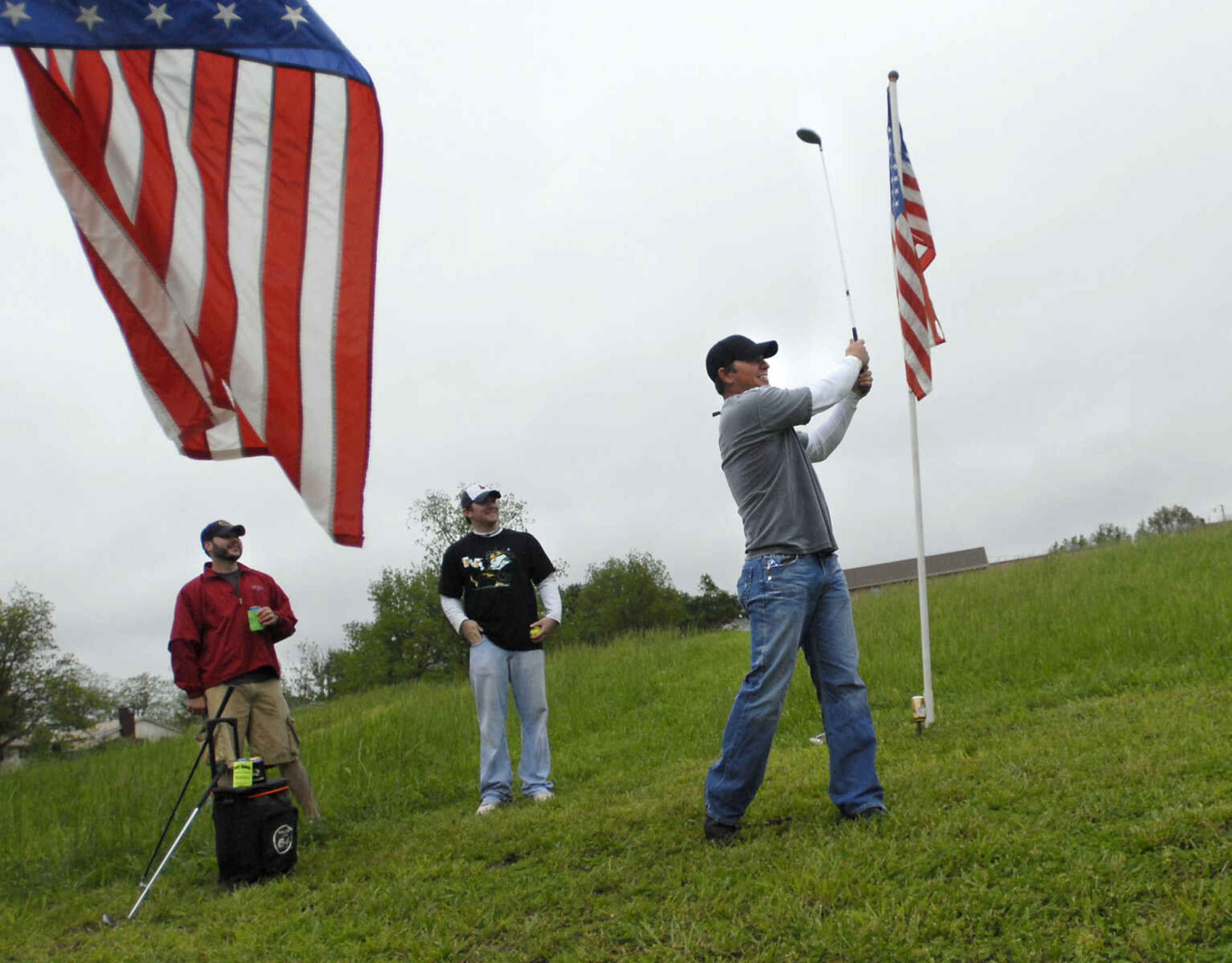 KRISTIN EBERTS ~ keberts@semissourian.com

Brett Burger, right, tees off as teammates Eric Schlosser, left, and Dustin Benson, center, watch during the Kow Pasture Klassic at Schlinder's Tavern in New Hamburg, Mo., on Saturday, May 14, 2011. Proceeds from the event benefit the Kenny Rogers Children's Center and the Missouri Veterans Home.