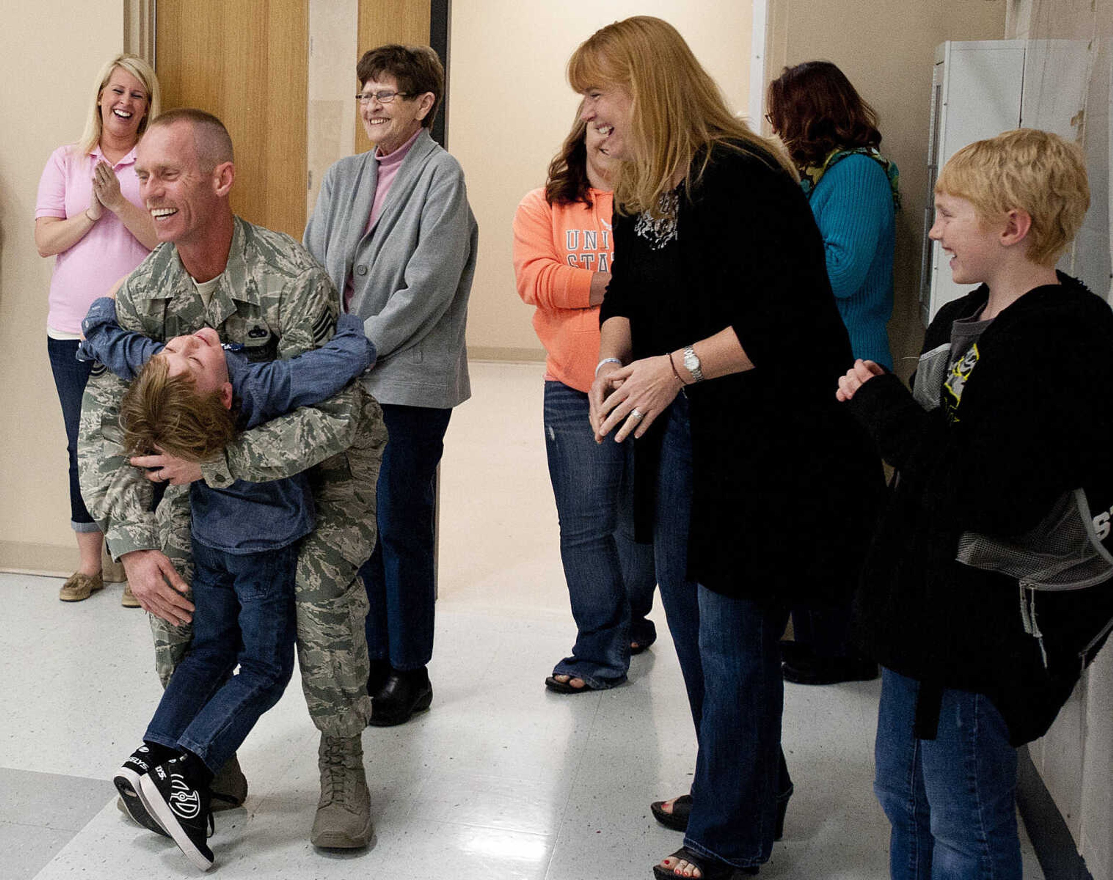 Eli Wiemr, 9, right, and LeAnne Wiemer watch as Gabriel Weimer, 6, runs to his father, Command Chief Master Sgt. Geoff Weimer after Geoff surprised him Friday, March 14, at Franklin Elementary School in Cape Girardeau. Sgt. Weimer is on leave from the Air Force after being deployed in the Middle East since Oct., and surprised his three sons, Geordan, 11, Eli, 9, and Gabriel, 6, in their respective classes.