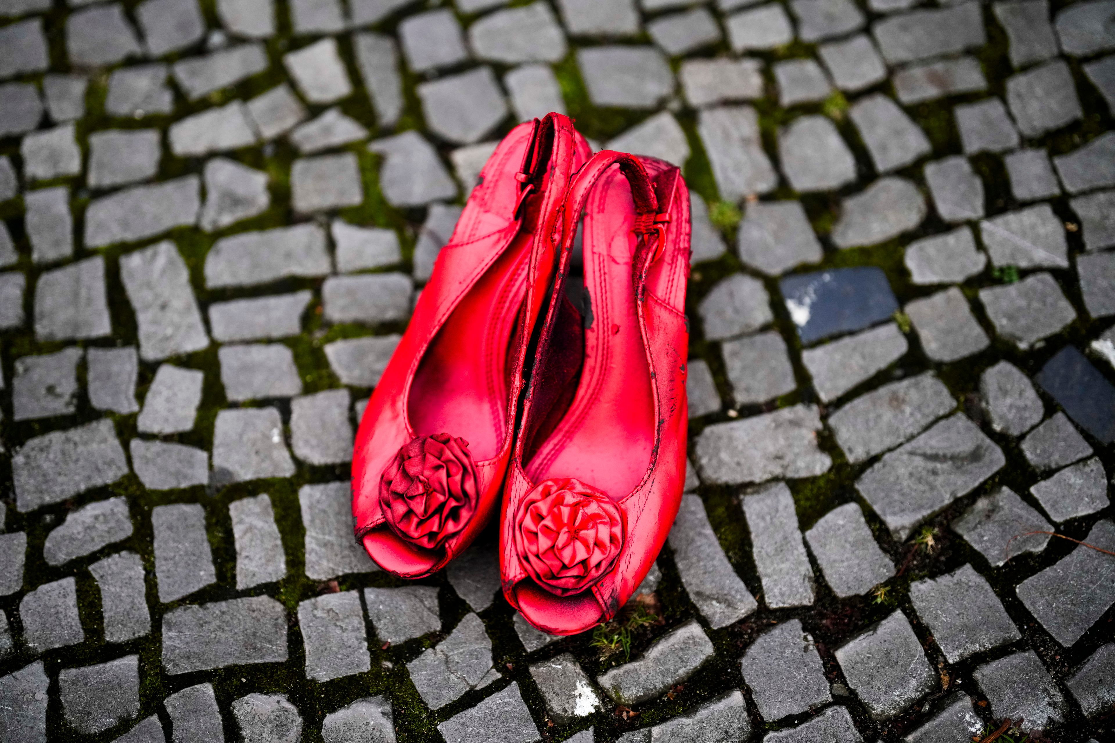 Red shoes placed on the ground as a symbol against the violence on women, during a rally marking the International Day for the Elimination of Violence Against Women in Berlin, Germany, Monday, Nov. 25, 2024. (AP Photo/Markus Schreiber)