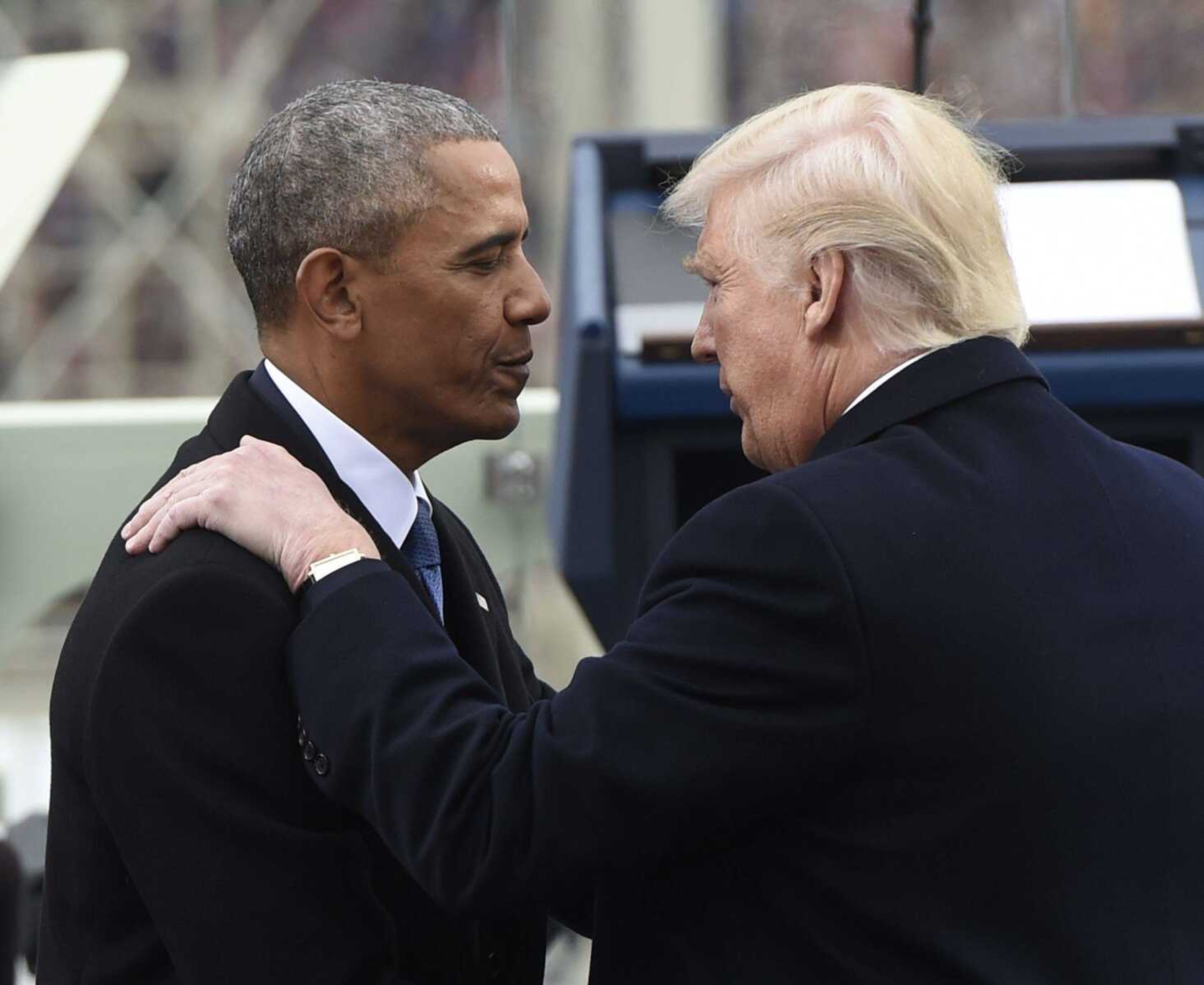 President Barack Obama speaks with President-elect Donald Trump during the presidential inauguration Friday at the U.S. Capitol in Washington.