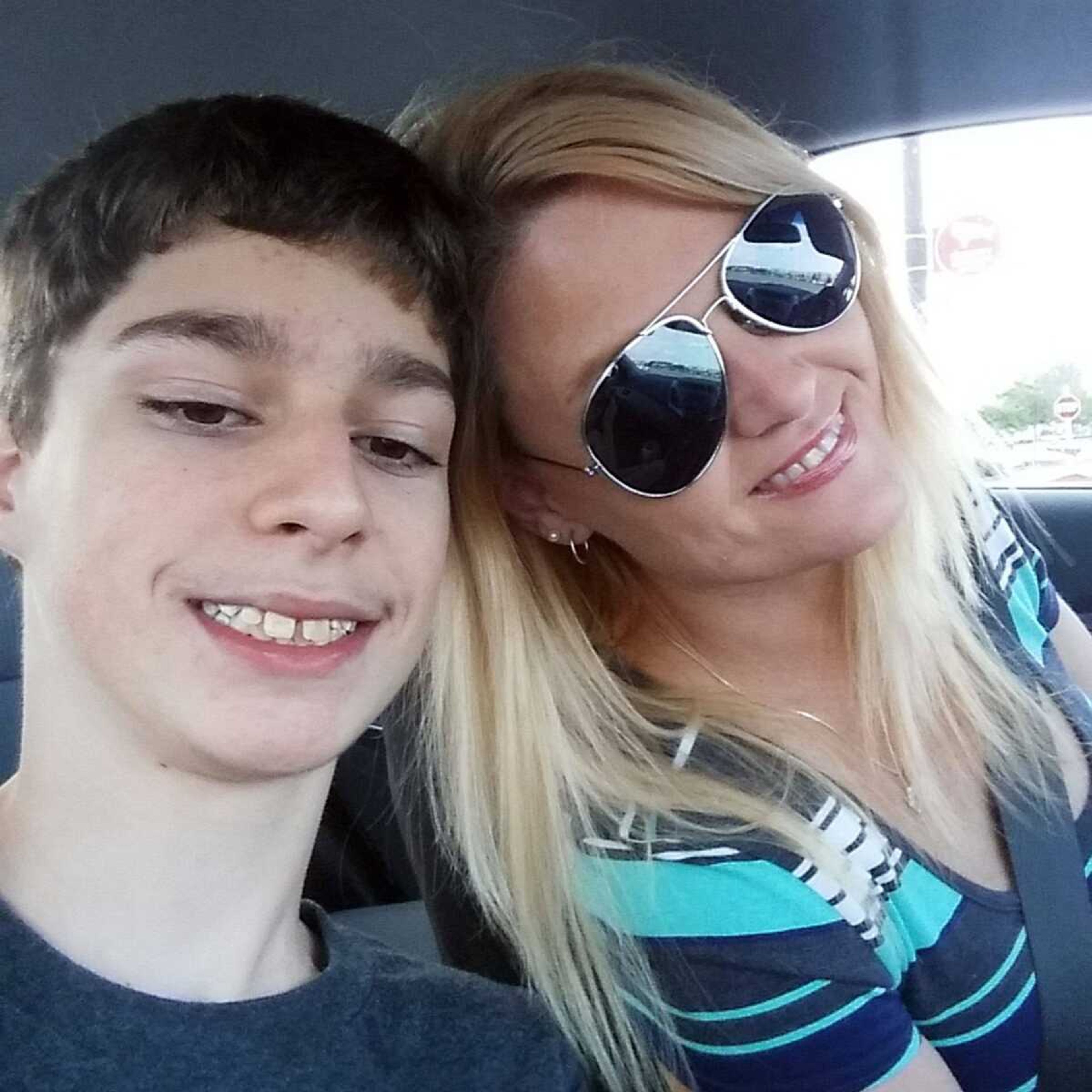 Alex Hoover poses for a photo with his mother, Rene. Alex Hoover, an Alabama teen with a terminal heart condition, has not returned to school because of a dispute with school officials. (Rene Hoover via AP)