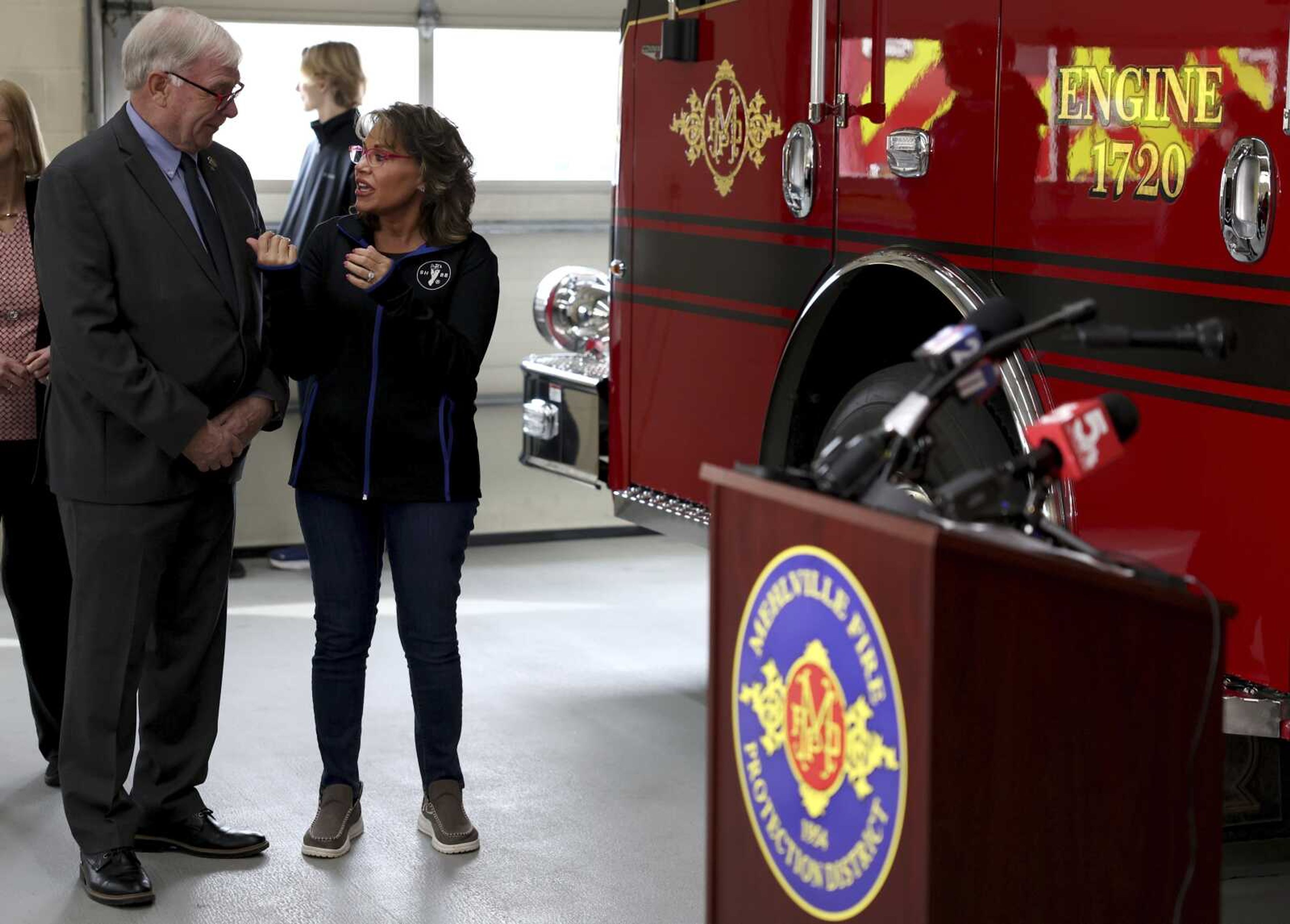 State Rep. Jim Murphy, left, speaks with Monica Kelsey, right, founder of Safe Haven Baby Box, before a news conference Monday at Mehlville Fire District Station 2 in south St. Louis County. A newborn baby is healthy and in state custody after being left in the station's box Thursday.