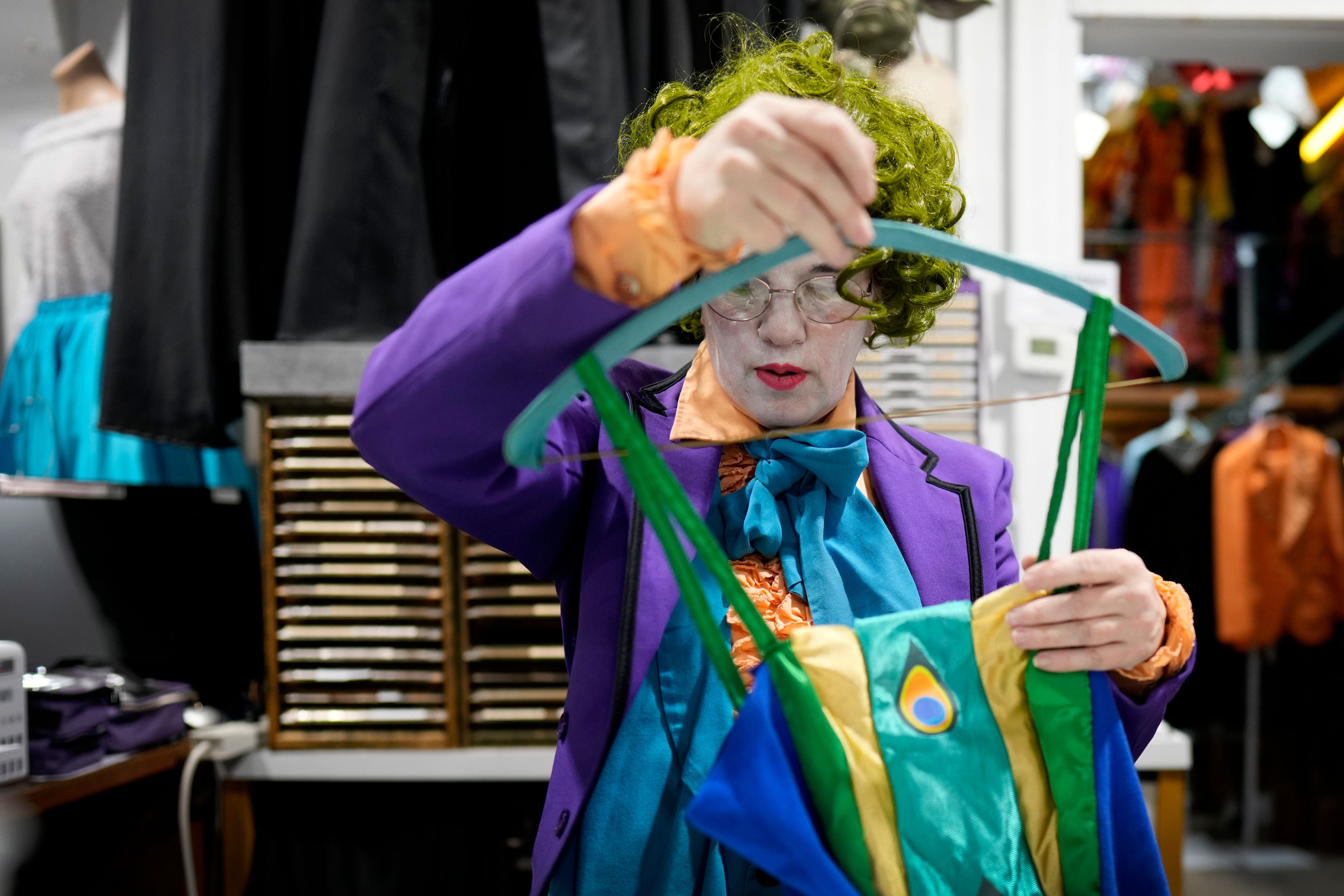 Michelle Nielsen prepares a costume for display at The Theatrical Shop, Tuesday, Oct. 29, 2024, in West Des Moines, Iowa. (AP Photo/Charlie Neibergall)