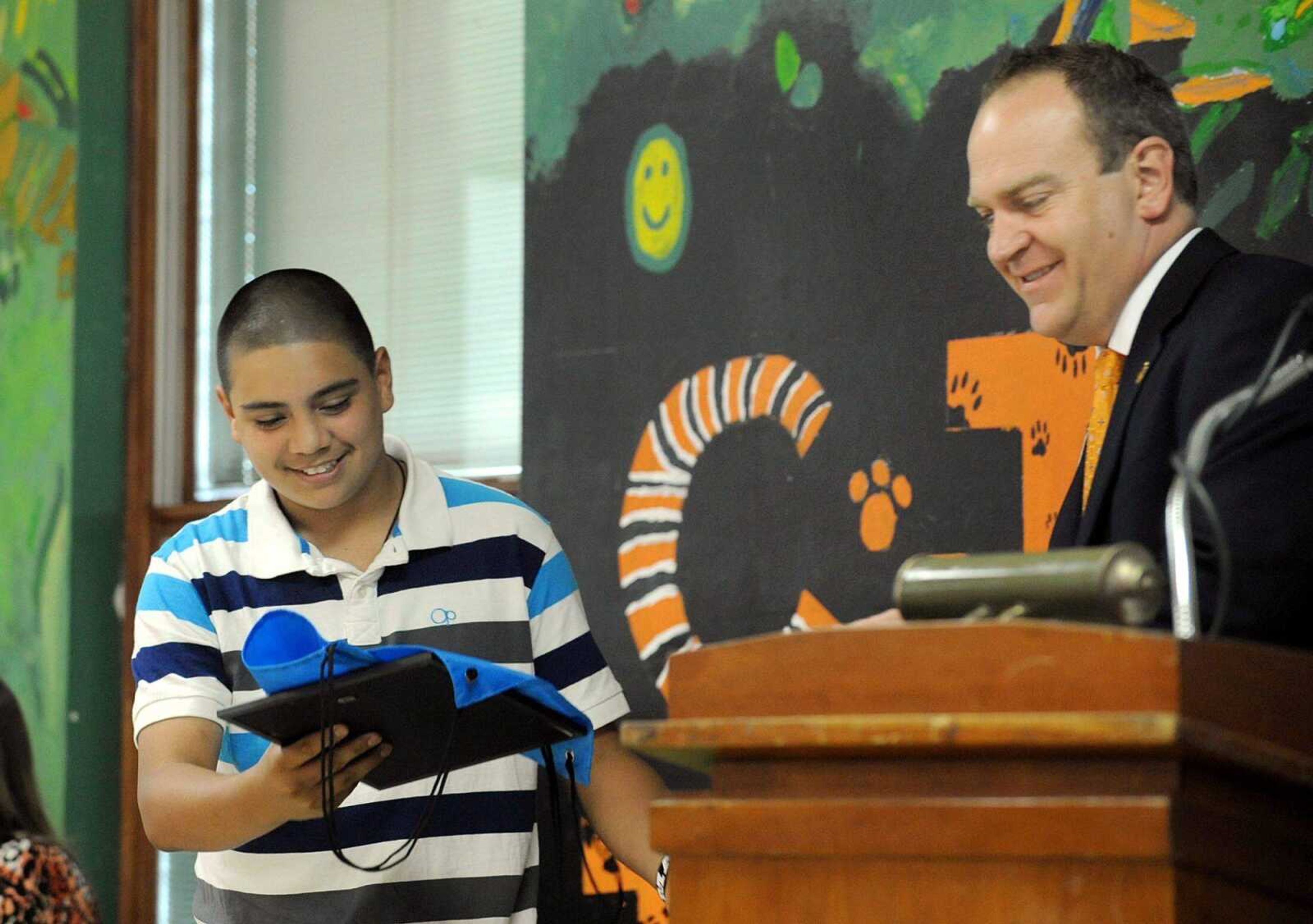 Central Junior High School assistant principal Alan Bruns hands seventh-grade student Noah Faulkner his award Tuesday night, during the Principal&#8217;s Dinner at the junior high school. Select seventh- and eighth-grade students were honored by their teachers during the dinner. (Laura Simon)