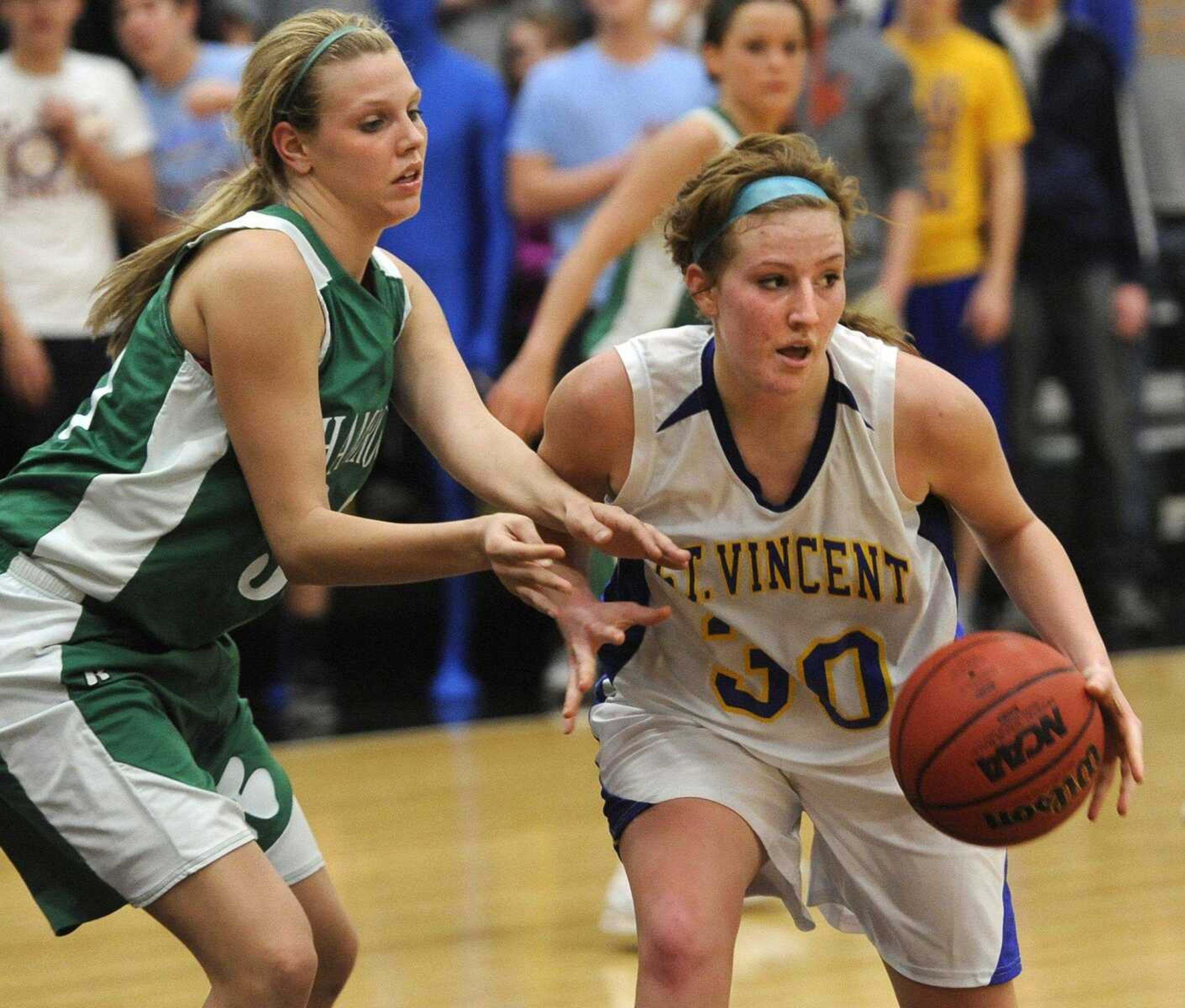 St. Vincent's Kali Wingerter looks to pass while defended by New Haven's Kayla Oetterer during the fourth quarter Friday. Wingerter scored 12 points for the Indians.