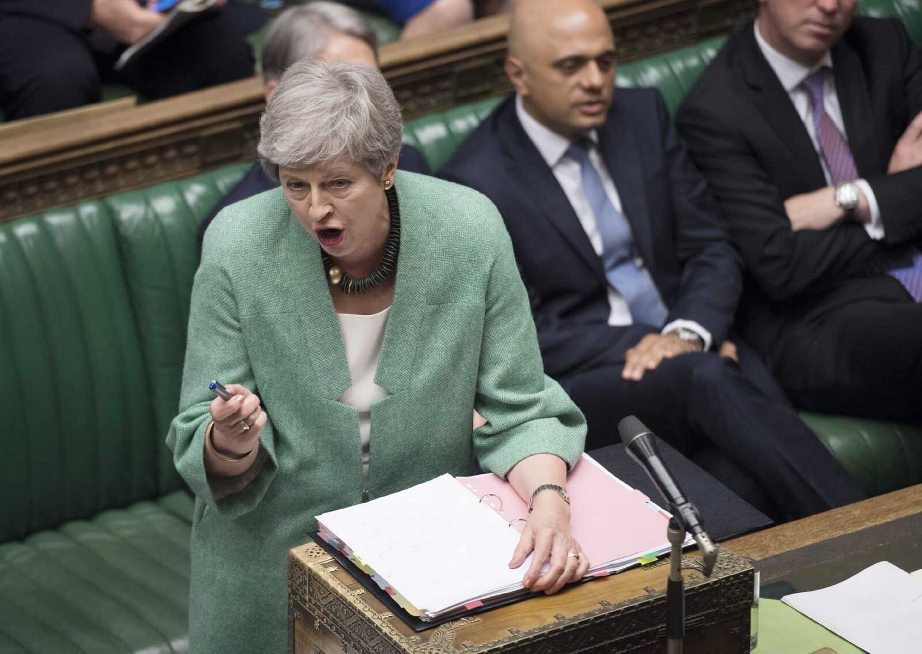 Britain's Prime Minister Theresa May speaks during Question Time inside the House of Commons in London. Britain's ambassador to the United States, veteran diplomat Kim Darroch resigned Wednesday, prompting May and other British politicians to praise Darroch.