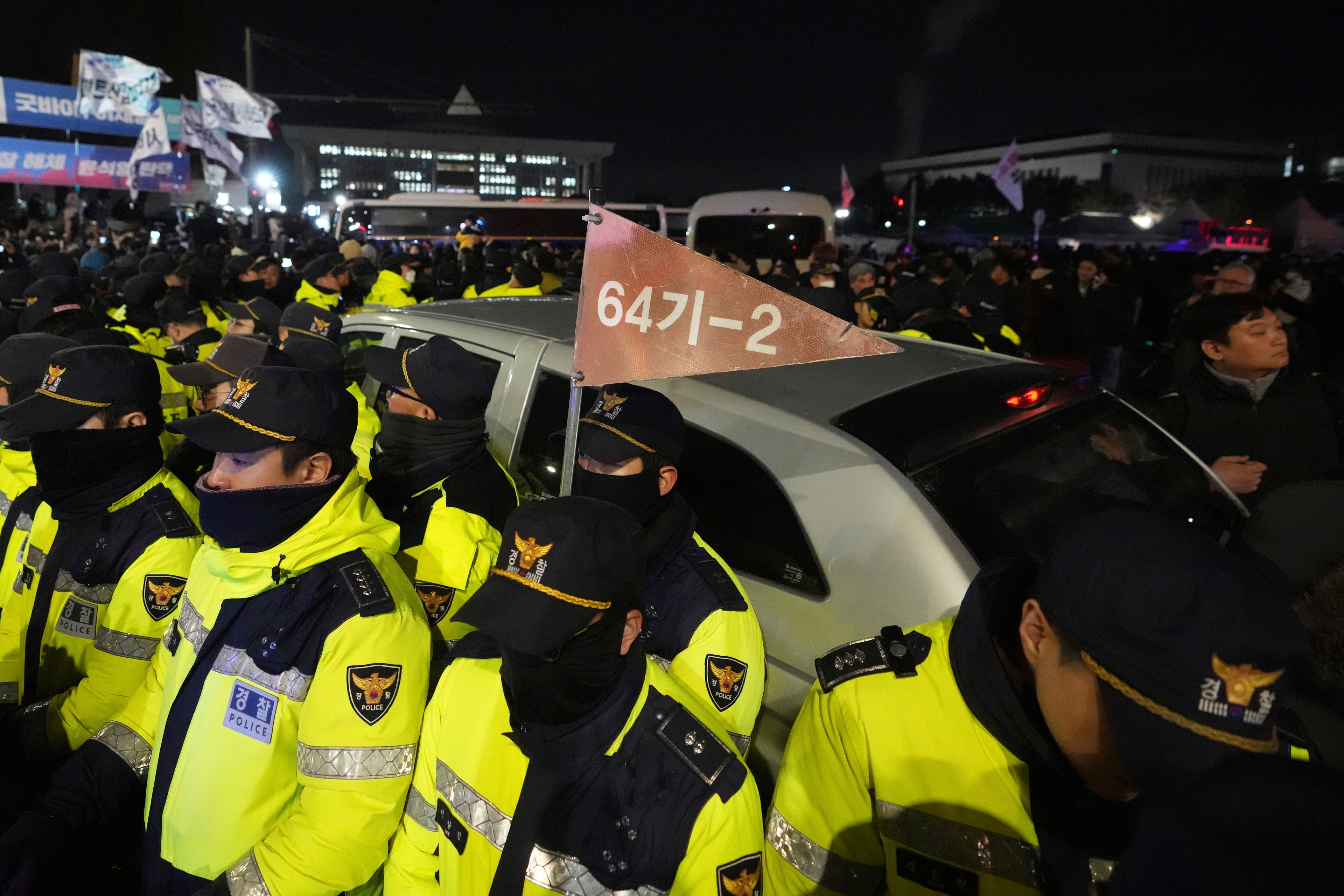 Police officers stand outside the National Assembly in Seoul, South Korea, Wednesday, Dec. 4, 2024. (AP Photo/Lee Jin-man)