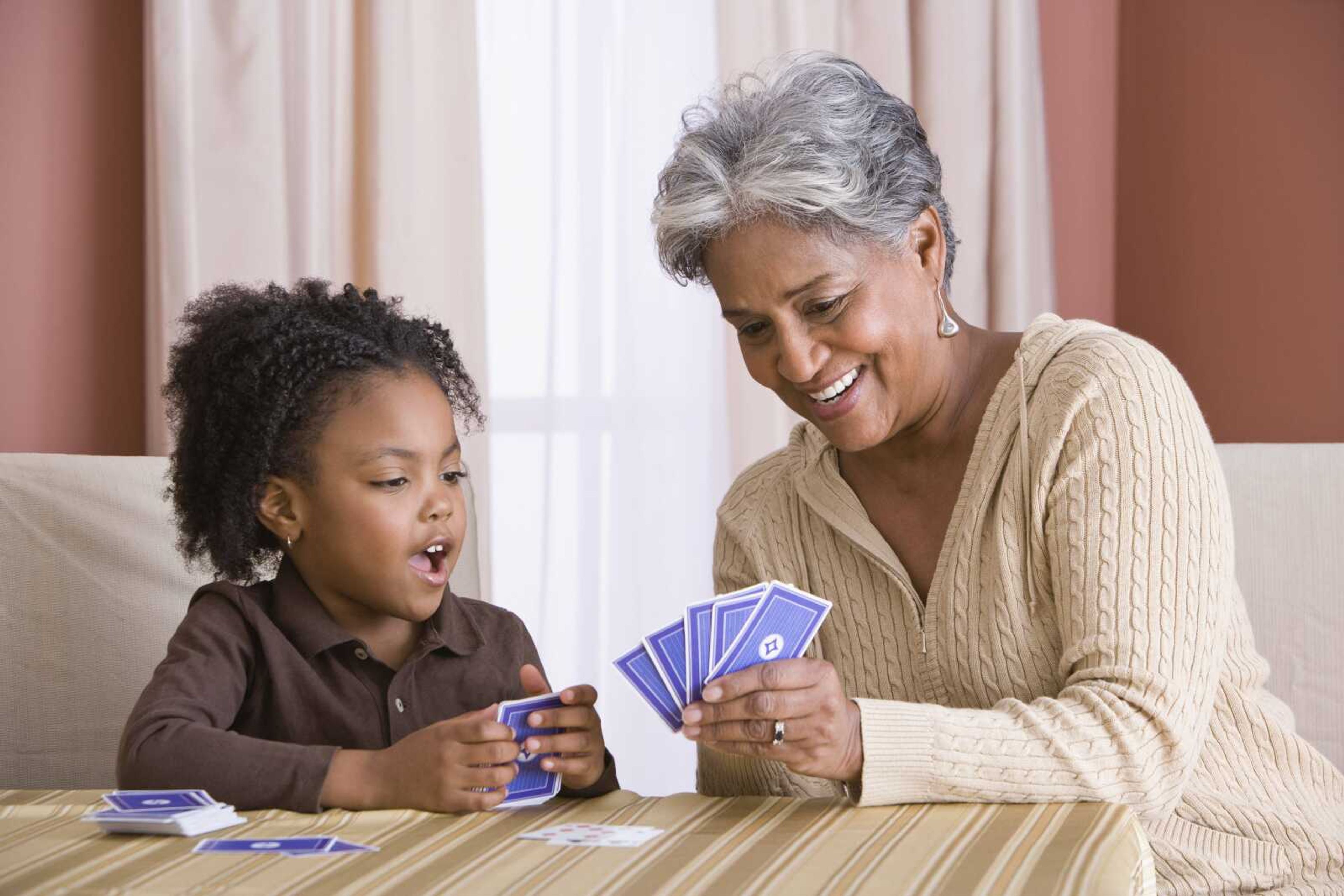 Grandmother and granddaughter playing cards