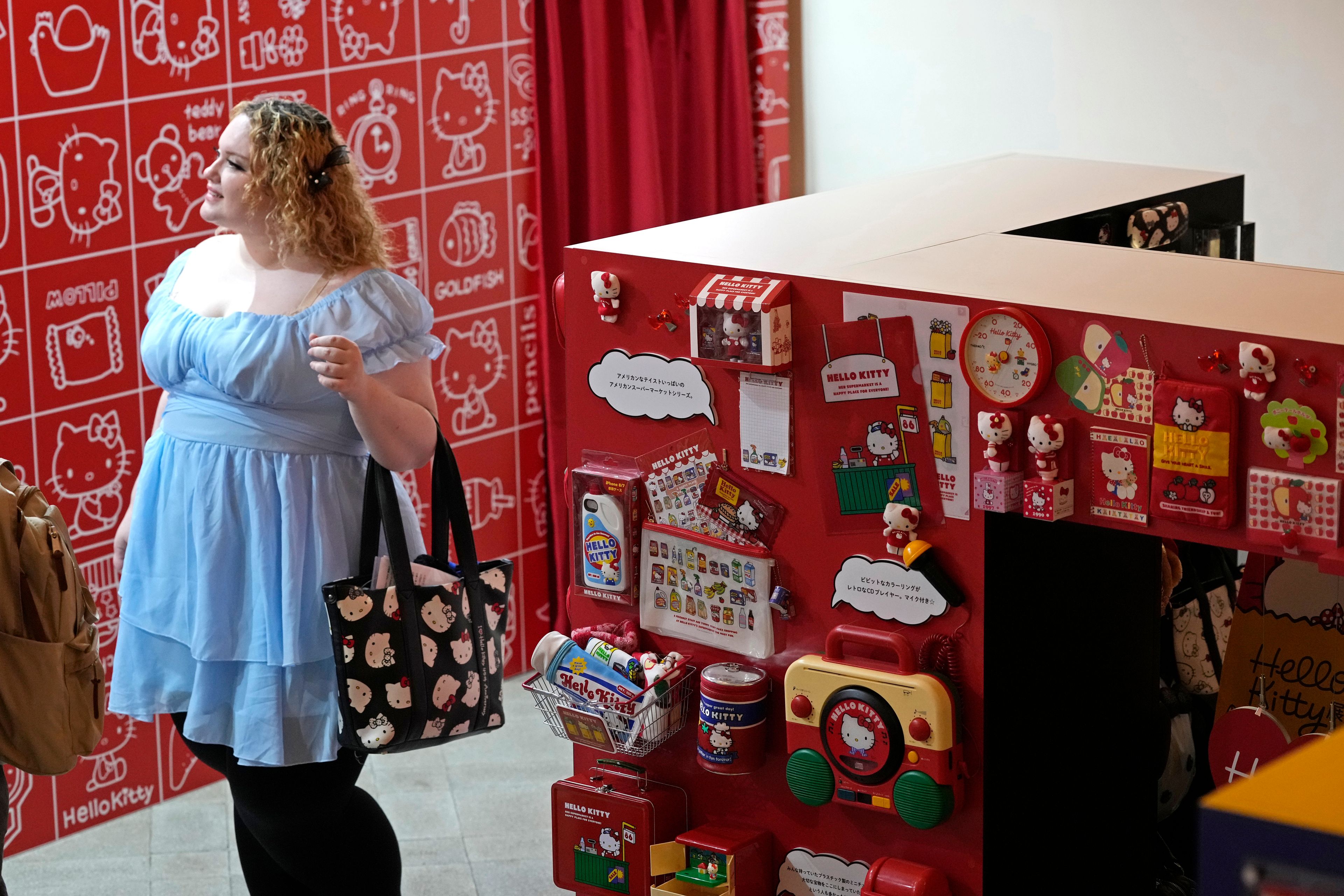 A visitor looks at giant Hello Kitty display at the exhibition "As I change, so does she," marking the 50th anniversary of Hello Kitty at the Tokyo National Museum in Tokyo Wednesday, Oct. 30, 2024. (AP Photo/Shuji Kajiyama)