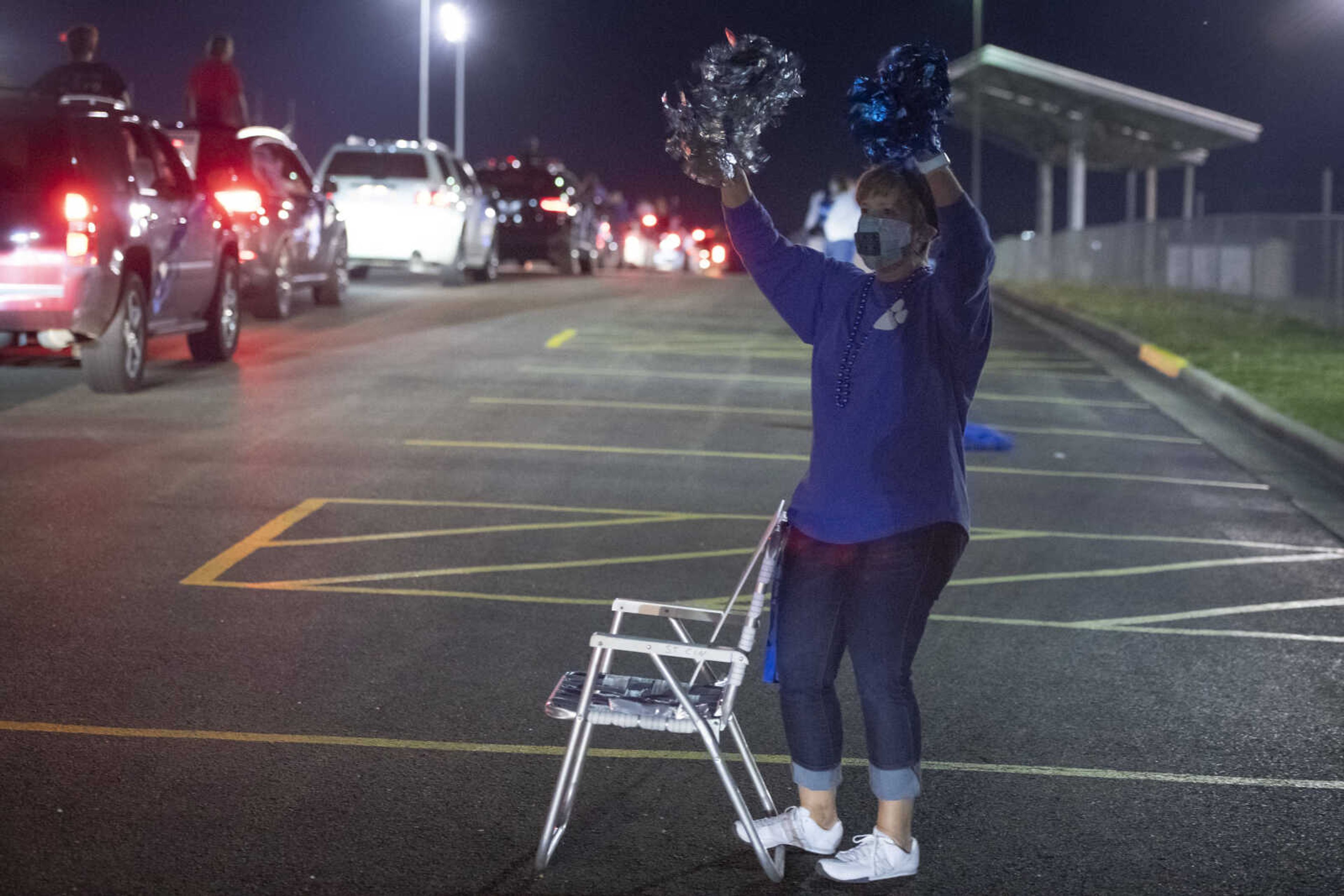 Bonnie Westrich, the principal's secretary at Notre Dame Regional High School, waves during a "Friday night lights" senior drive-through event Friday, May 1, 2020, at the Cape Girardeau school.