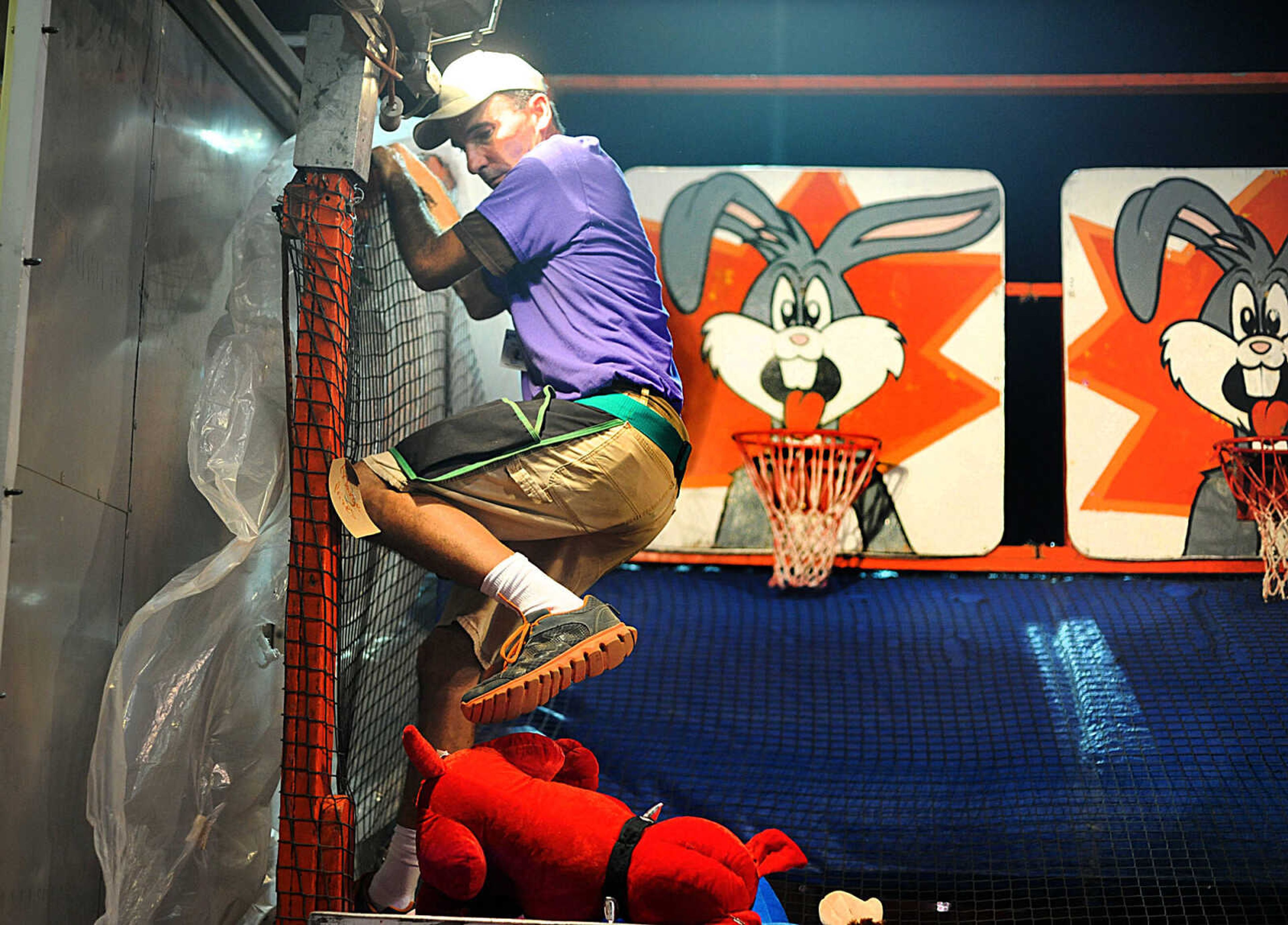 LAURA SIMON ~ lsimon@semissourian.com

Daniel Miller takes down stuffed animals as rain moves into area during the SEMO District Fair, Wednesday, Sept. 10, 2014.