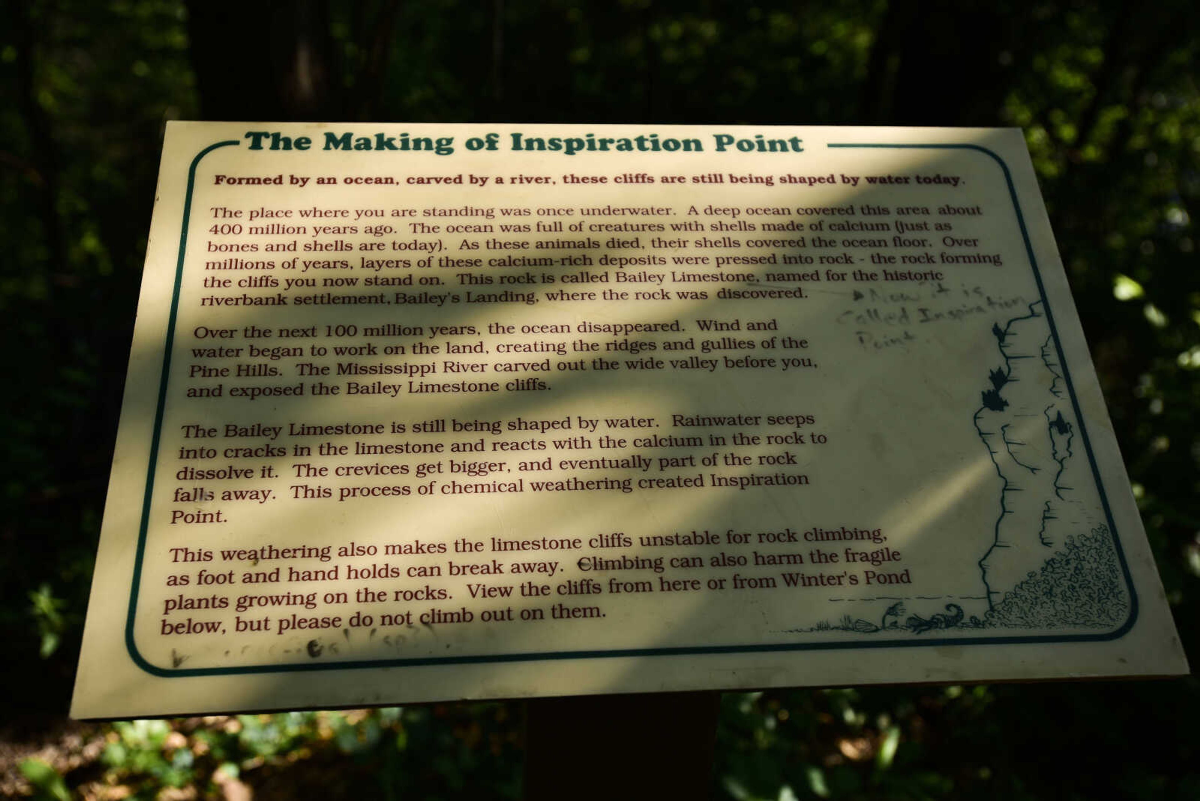 A sign detailing the history of Inspiration Point, along with one penciled in adjustment, stands along the trail Wednesday, Aug. 1, 2018, near Wolf Lake, Illinois.