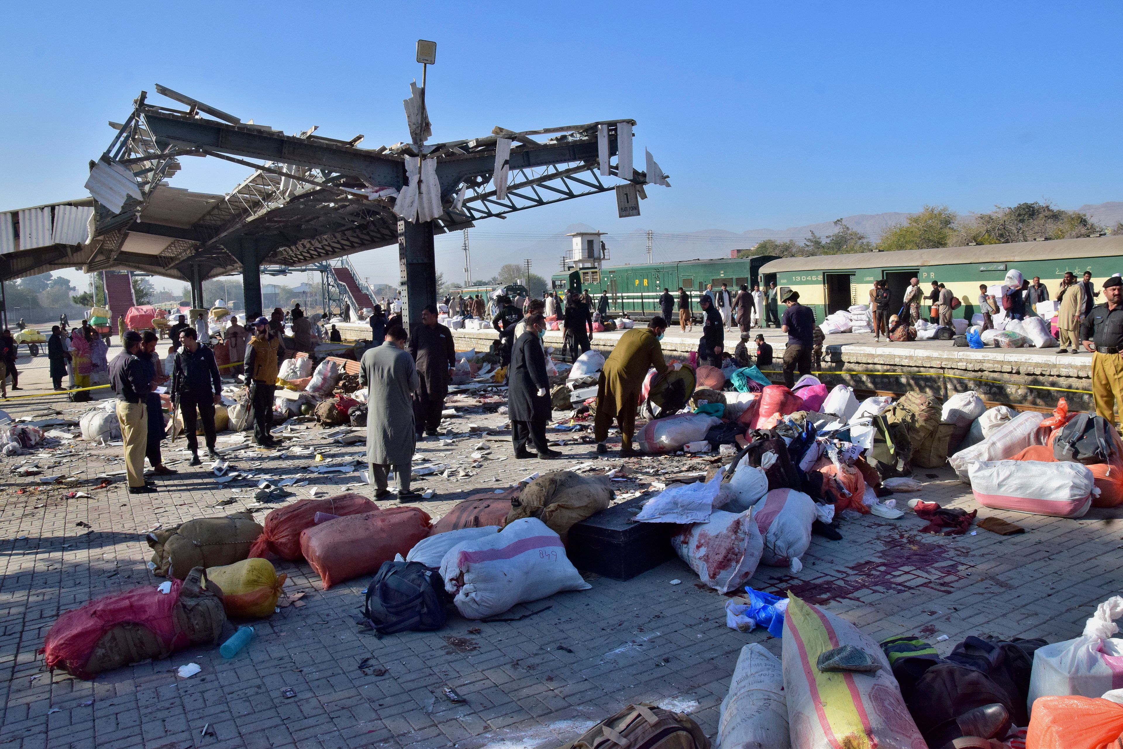 Security officials examine the site of a bomb explosion at railway station in Quetta, southwestern Pakistan, Saturday, Nov. 9, 2024. (AP Photo/Arshad Butt)