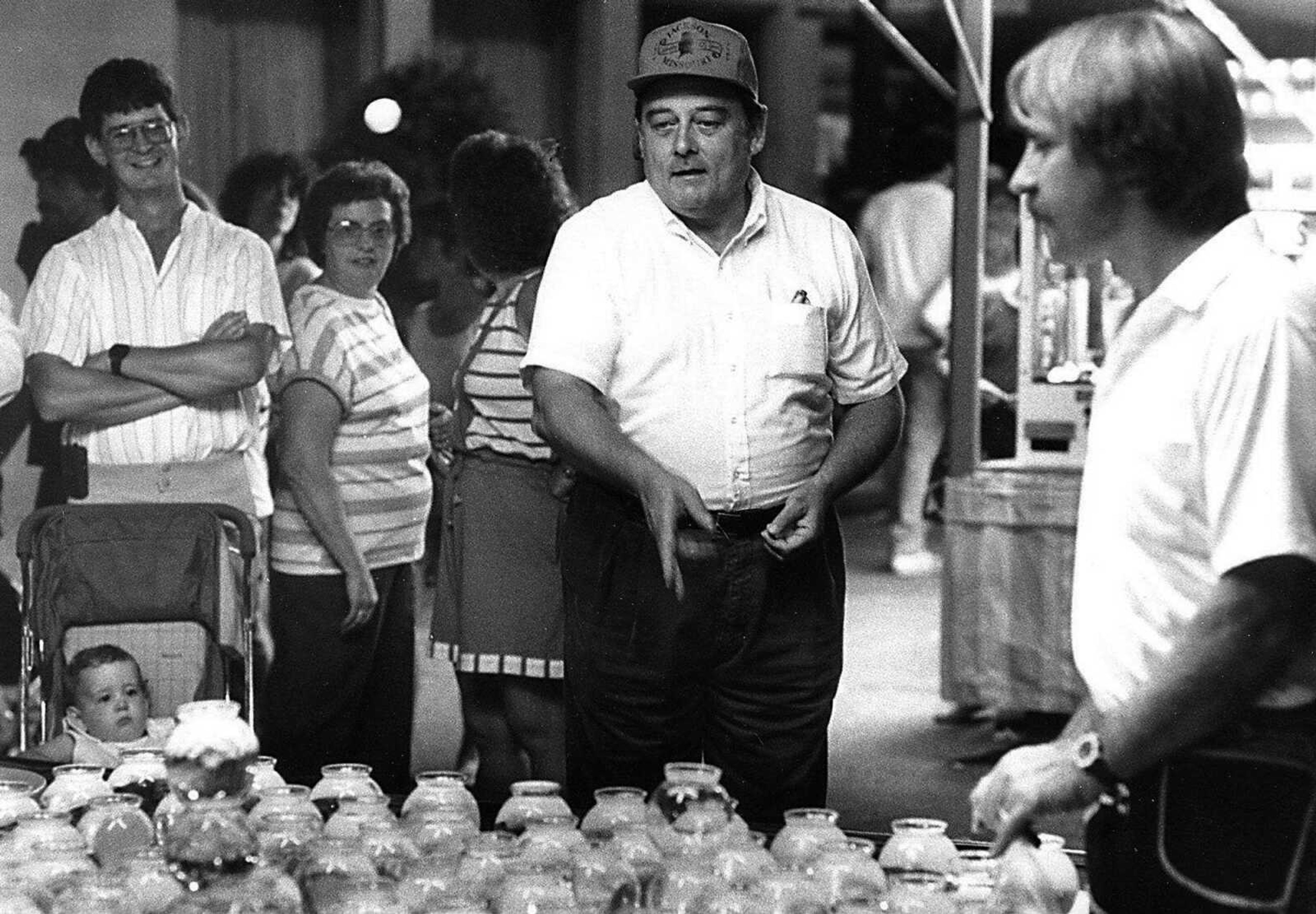 Congressman Bill Emerson tried his hand at "fishing" with ping-pong ball at Homecomers in 1989. (Fred Lynch)