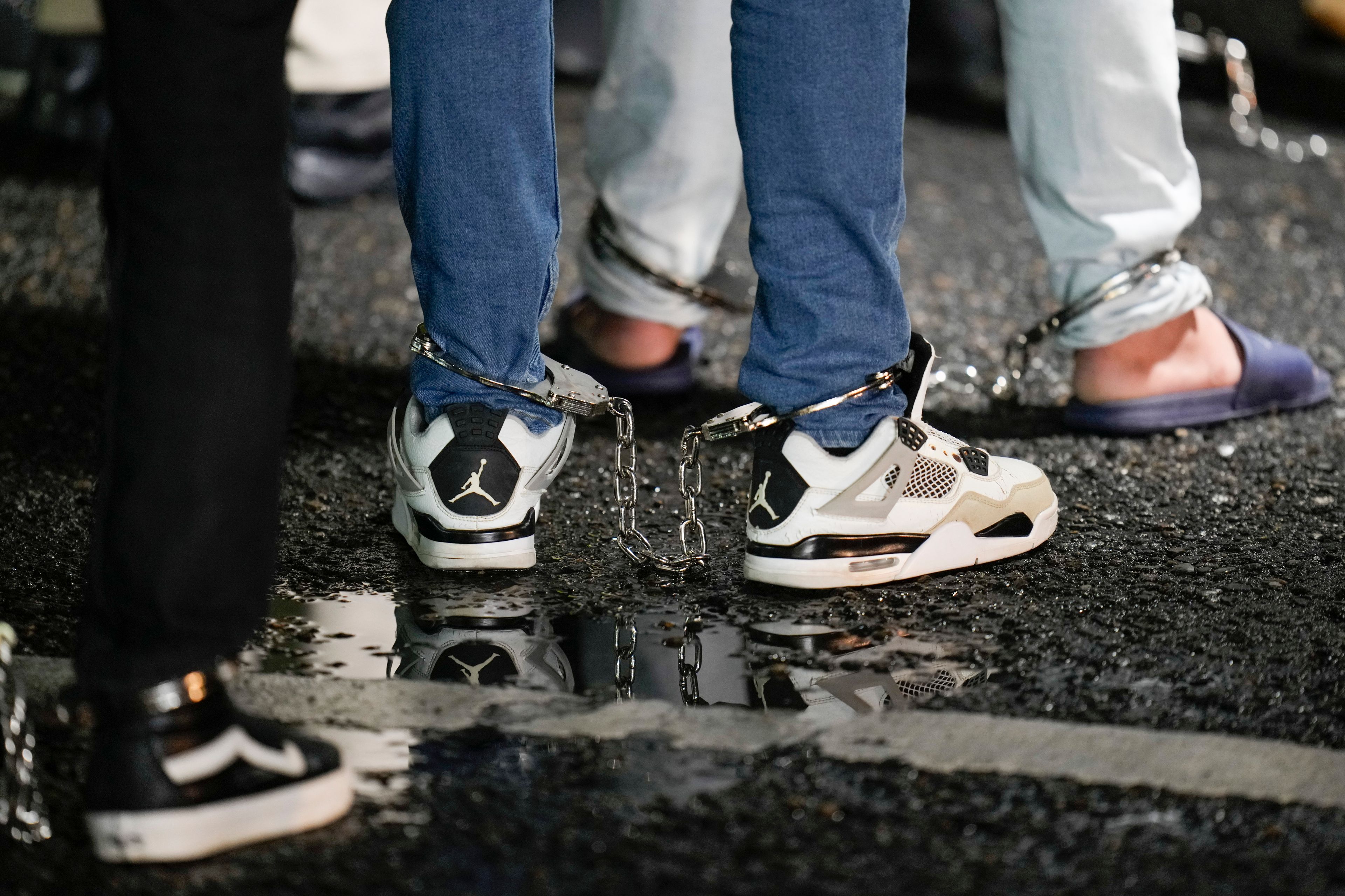 FILE - Shackled Ecuadorian migrants line up to board a plane for deportation from the Albrook airport in Panama City, Aug. 29, 2024. (AP Photo/Matias Delacroix, File)