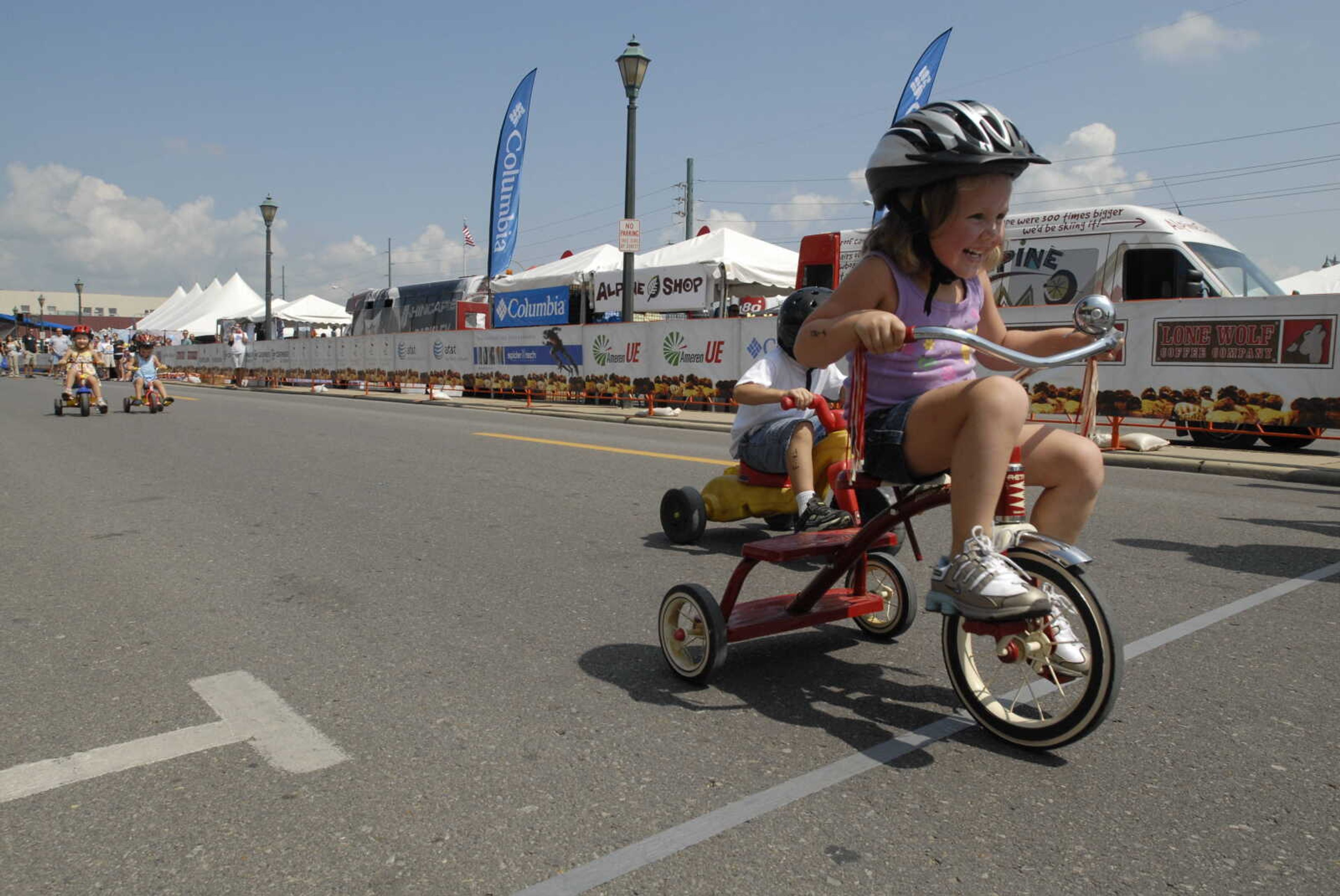 Madison Glaus of Dexter, Mo. wins a 30-yard tricycle race.