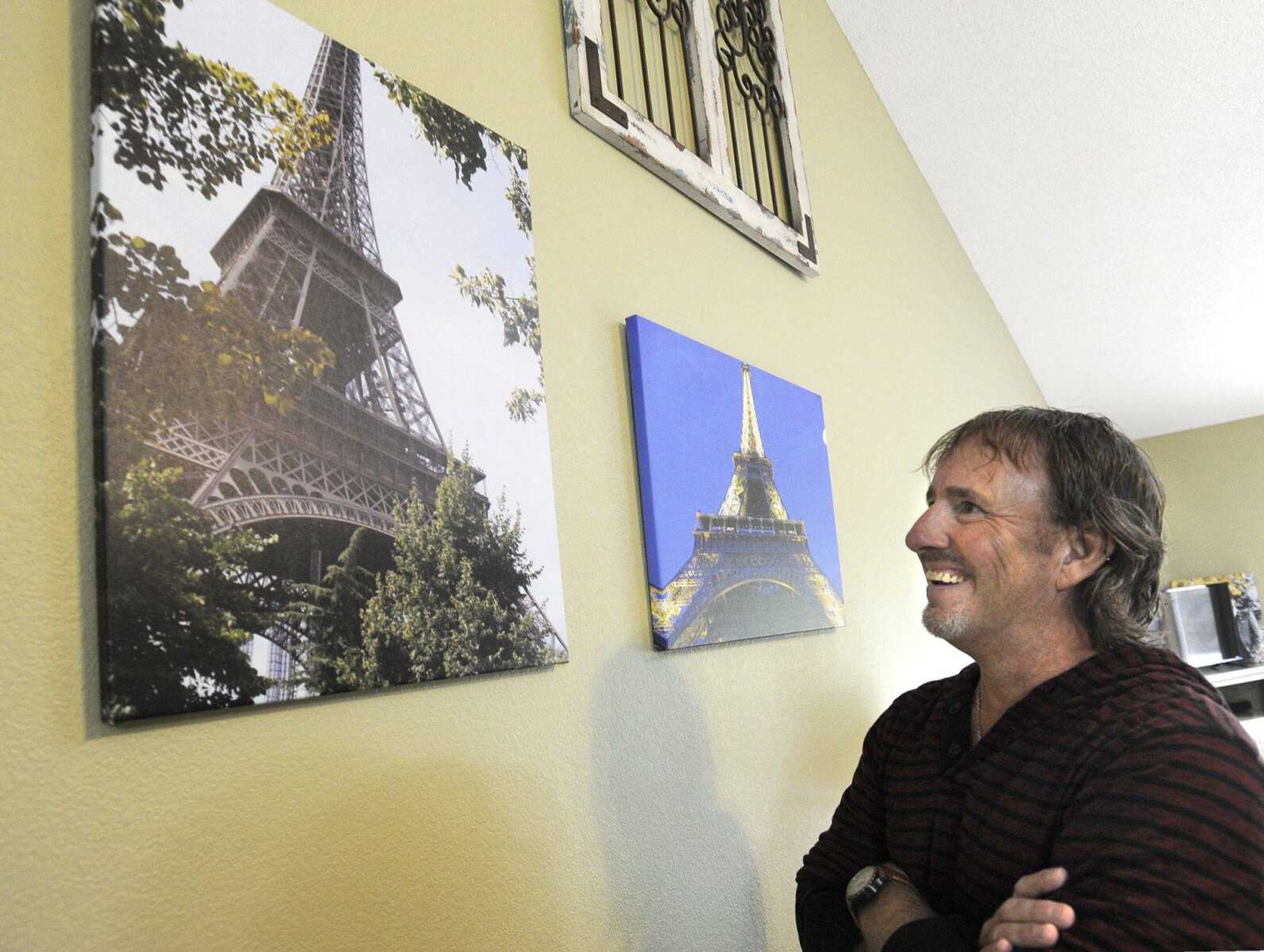 Jeff Bollinger admires the photographs of the Eiffel Tower he made while visiting Paris.