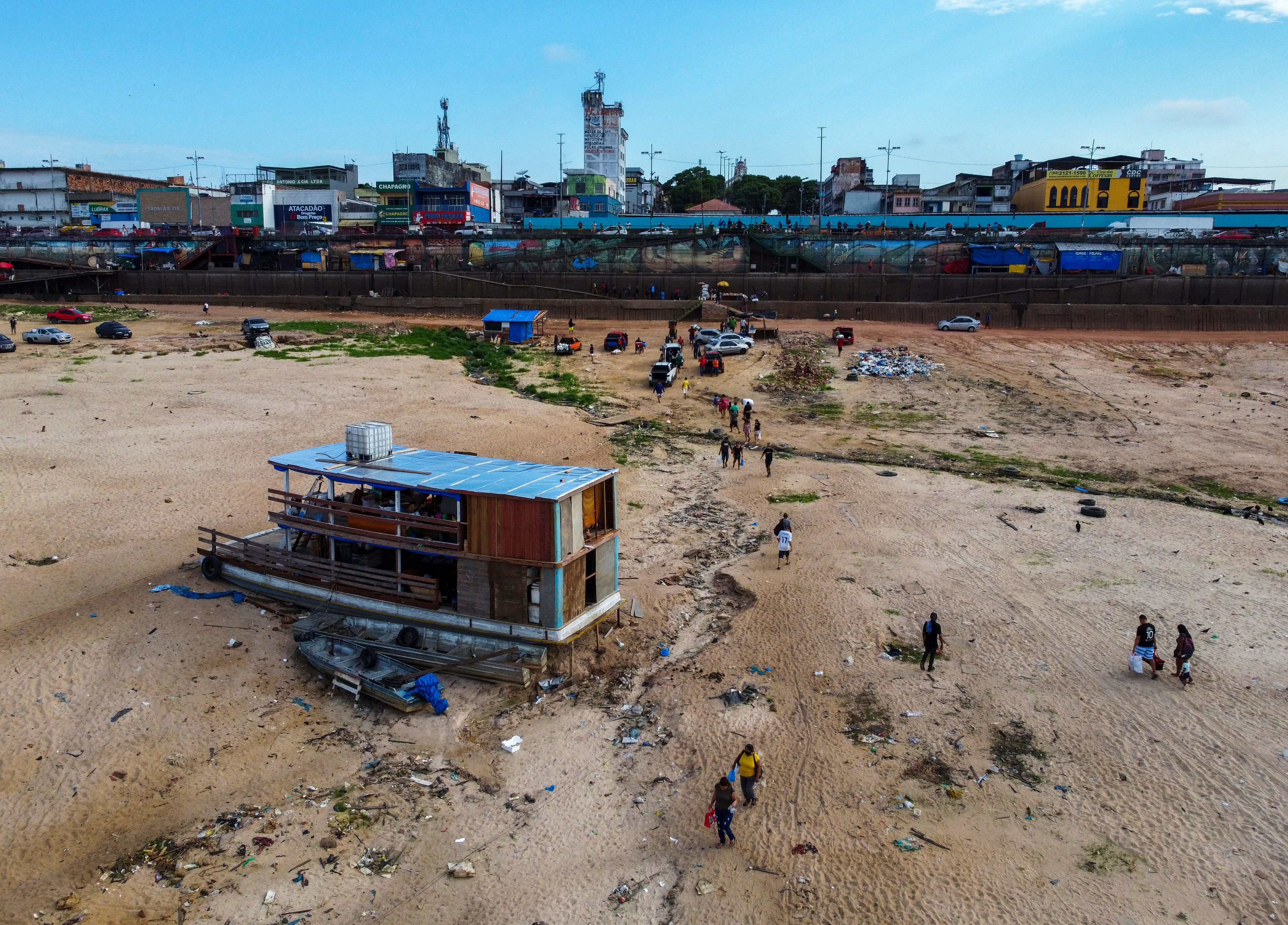 A boat is grounded in the Negro River at the port in Manaus, Amazonas state, Brazil, Friday, Oct. 4, 2024, amid severe drought. (AP Photo/Edmar Barros)